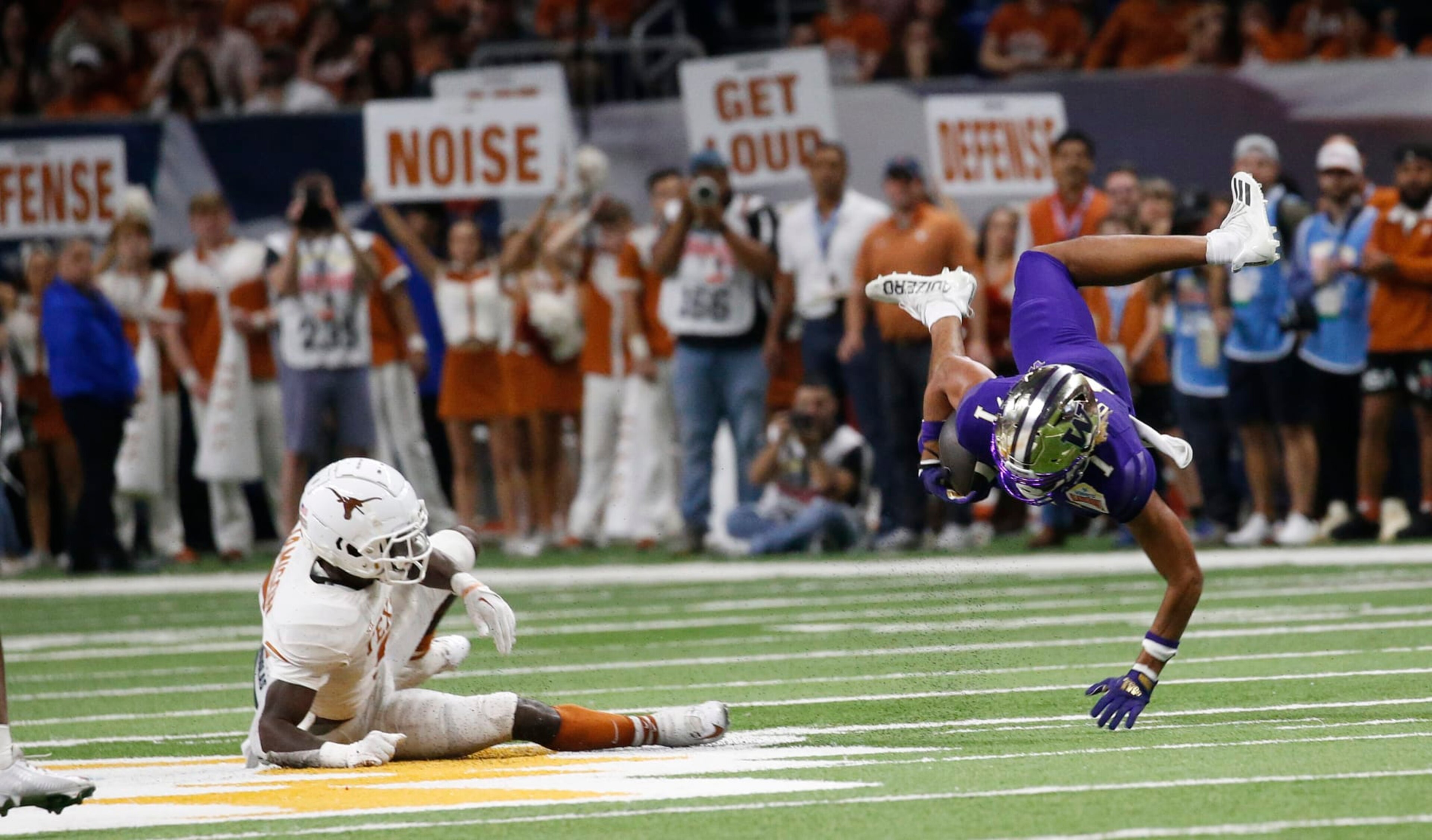 SAN ANTONIO, TX - DECEMBER 29: Rome Odunze #1 of the Washington Huskies is upended by DShawn Jamison #5 of the Texas Longhorns in the second half in the Valero Alamo Bowl at the Alamodome on December 29, 2022 in San Antonio, Texas. (Photo by Ronald Cortes/Getty Images) SAN ANTONIO, TX - DECEMBER 29: Rome Odunze #1 of the Washington Huskies is upended by DShawn Jamison #5 of the Texas Longhorns in the second half in the Valero Alamo Bowl at the Alamodome on December 29, 2022 in San Antonio, Texas. (Photo by Ronald Cortes/Getty Images)