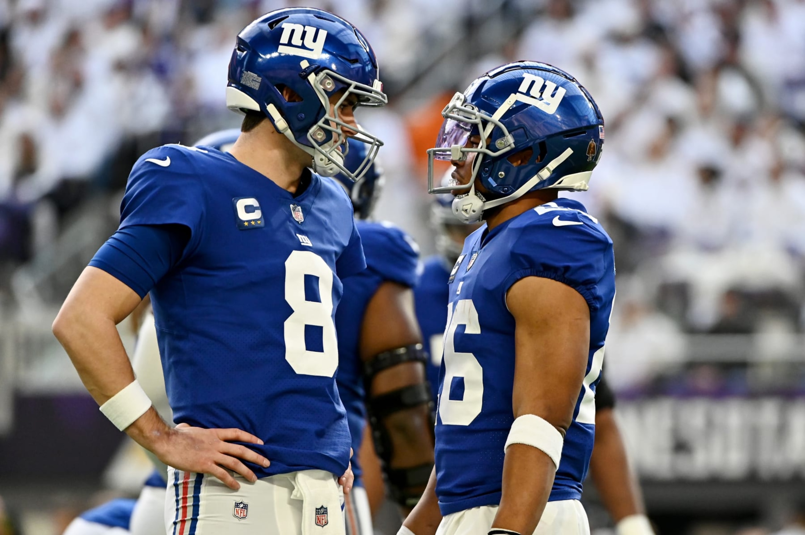 MINNEAPOLIS, MINNESOTA - DECEMBER 24: Daniel Jones #8 and Saquon Barkley #26 of the New York Giants speak on the field during the first half of the game against the Minnesota Vikings at U.S. Bank Stadium on December 24, 2022 in Minneapolis, Minnesota. (Photo by Stephen Maturen/Getty Images)
