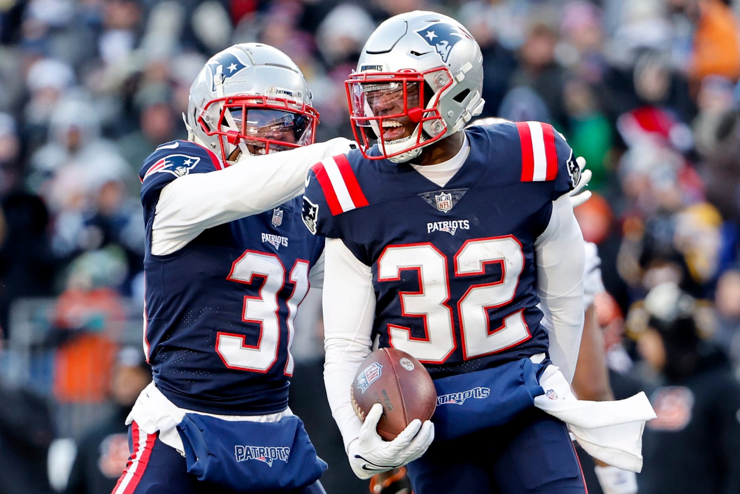 FOXBOROUGH, MASSACHUSETTS - DECEMBER 24: Jonathan Jones #31 of the New England Patriots hugs Devin McCourty #32 of the New England Patriots after McCourty's interception during the second quarter against the Cincinnati Bengals at Gillette Stadium on December 24, 2022 in Foxborough, Massachusetts. (Photo by Winslow Townson/Getty Images) FOXBOROUGH, MASSACHUSETTS - DECEMBER 24: Jonathan Jones #31 of the New England Patriots hugs Devin McCourty #32 of the New England Patriots after McCourty's interception during the second quarter against the Cincinnati Bengals at Gillette Stadium on December 24, 2022 in Foxborough, Massachusetts. (Photo by Winslow Townson/Getty Images)