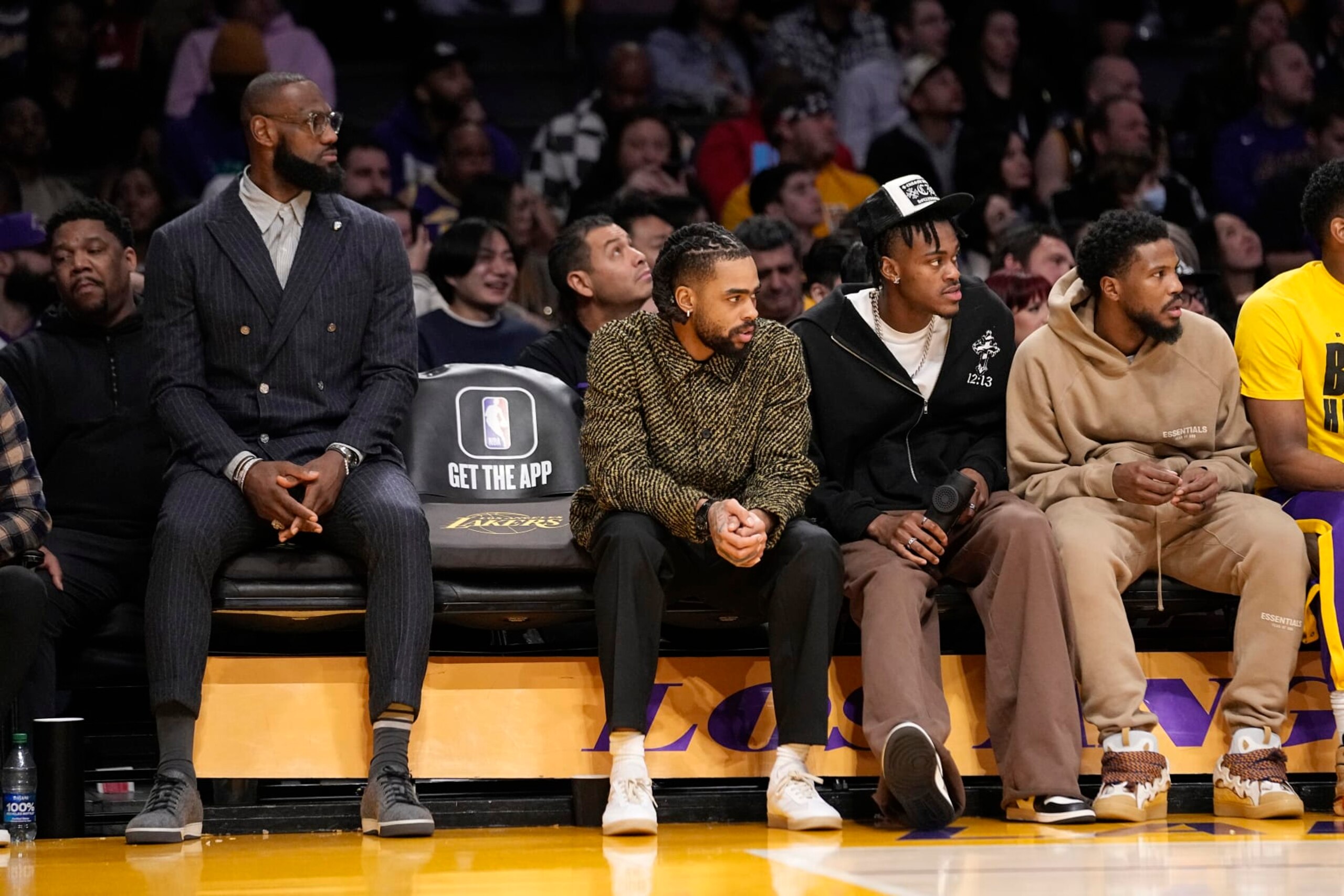 Los Angeles Lakers' LeBron James, left, sits on the bench with D'Angelo Russell, second from left, Jarred Vanderbilt, second from right, and Malik Beasley during the second half of an NBA basketball game against the Milwaukee Bucks Thursday, Feb. 9, 2023, in Los Angeles. (AP Photo/Mark J. Terrill)