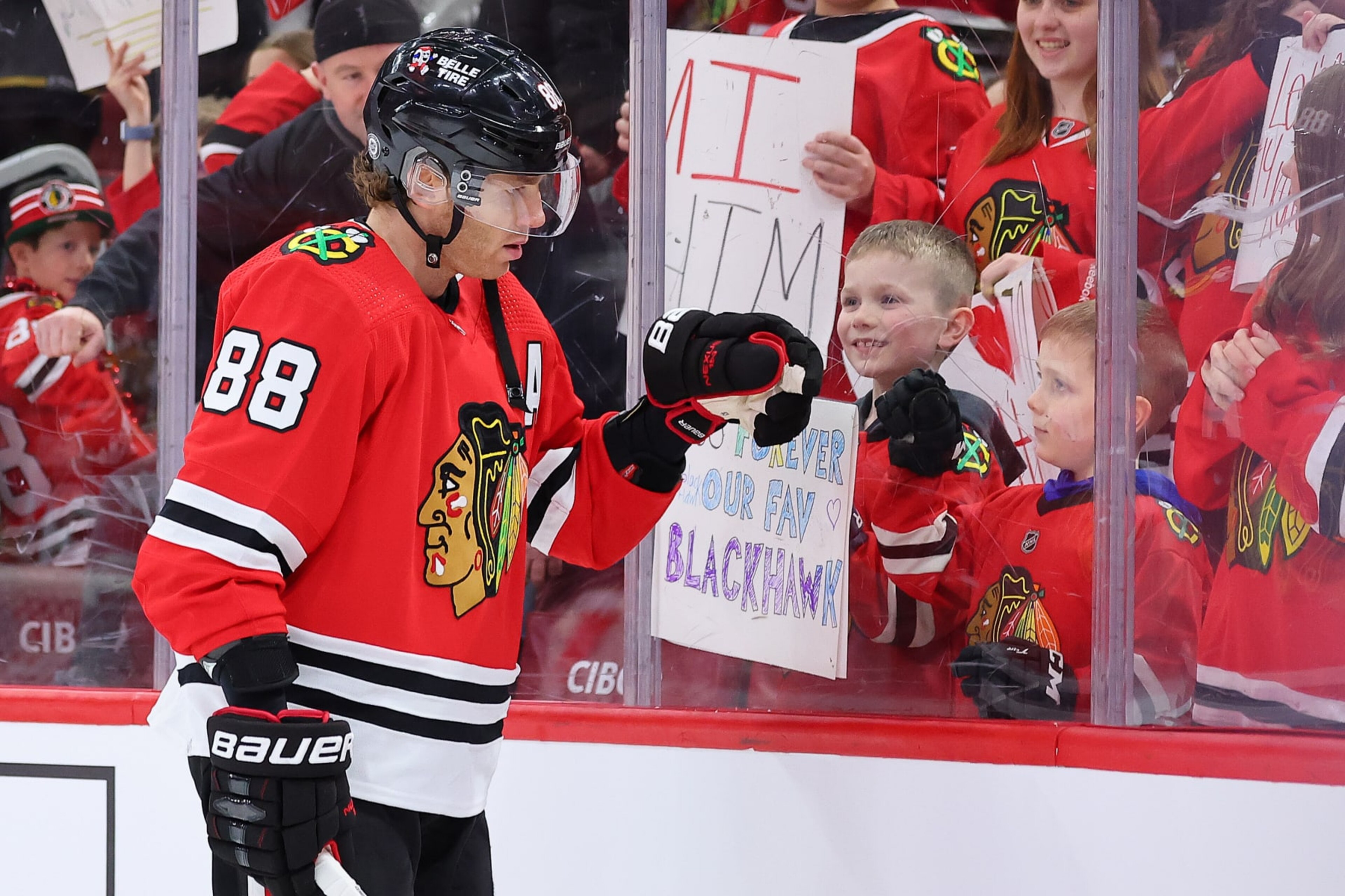 CHICAGO, ILLINOIS - FEBRUARY 21: Patrick Kane #88 of the Chicago Blackhawks fist bumps a young fan prior to the game against the Vegas Golden Knights at United Center on February 21, 2023 in Chicago, Illinois. (Photo by Michael Reaves/Getty Images)