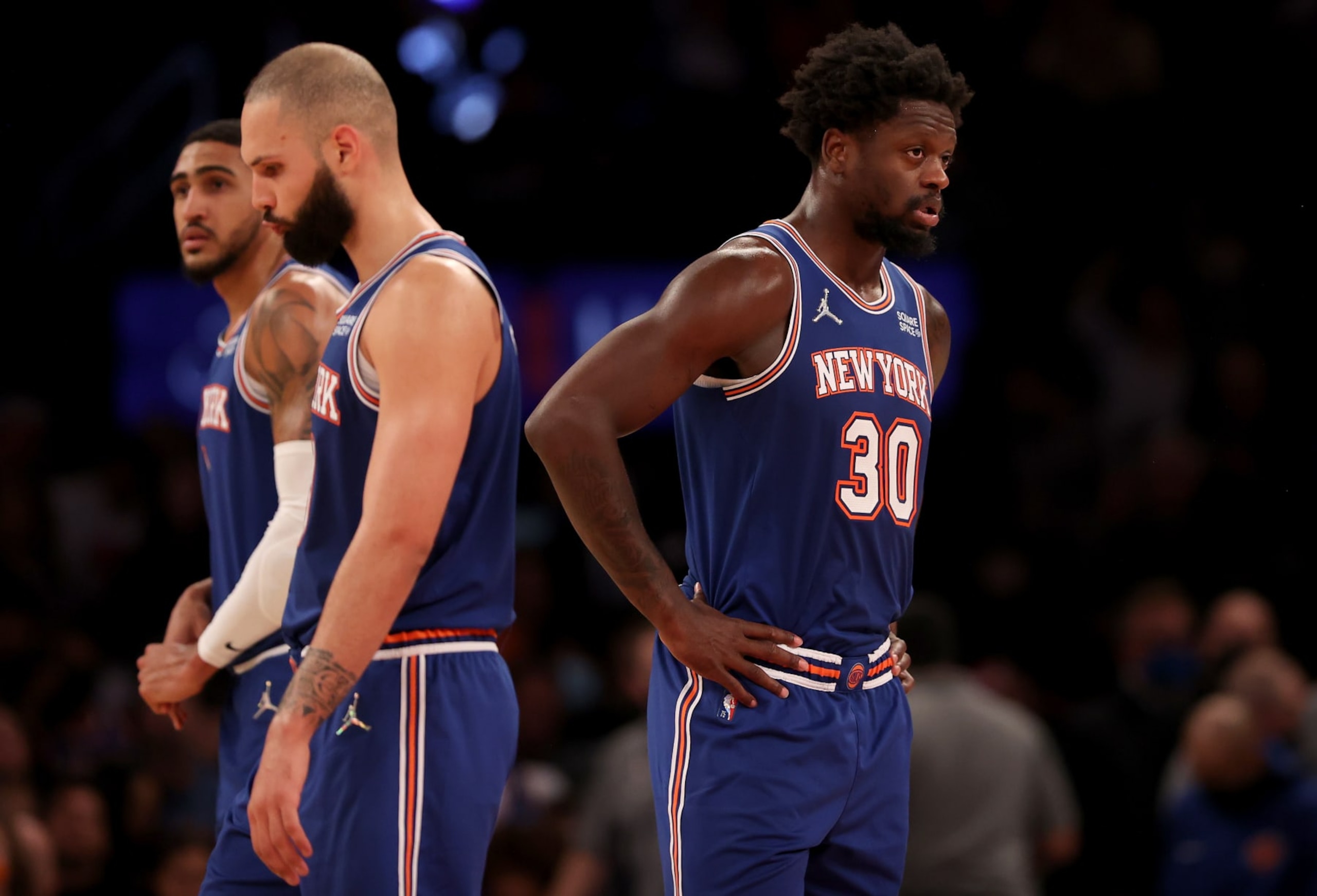 NEW YORK, NEW YORK - DECEMBER 04:  Julius Randle #30 of the New York Knicks reacts to the loss with teammates Evan Fournier #13 and Obi Toppin #1 late in the fourth quarter against the Denver Nuggets at Madison Square Garden on December 04, 2021 in New York City. The Denver Nuggets defeated the New York Knicks 113-99. NOTE TO USER: User expressly acknowledges and agrees that, by downloading and or using this photograph, User is consenting to the terms and conditions of the Getty Images License Agreement. (Photo by Elsa/Getty Images)