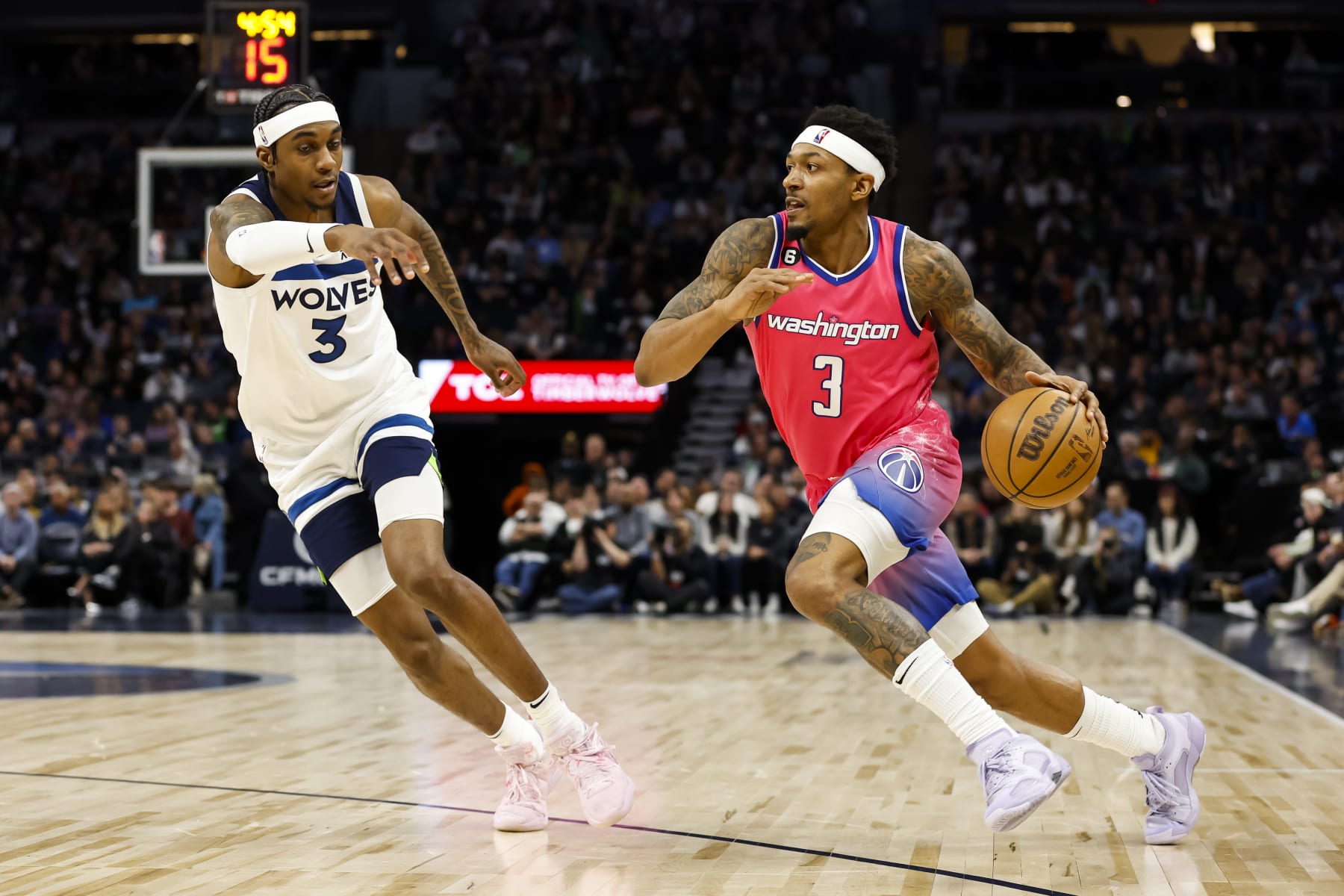 MINNEAPOLIS, MN - FEBRUARY 16: Bradley Beal #3 of the Washington Wizards drives to the basket while Jaden McDaniels #3 of the Minnesota Timberwolves defends in the fourth quarter of the game at Target Center on February 16, 2023 in Minneapolis, Minnesota. The Wizards defeated the Timberwolves 114-106. NOTE TO USER: User expressly acknowledges and agrees that, by downloading and or using this Photograph, user is consenting to the terms and conditions of the Getty Images License Agreement. (Photo by David Berding/Getty Images)
