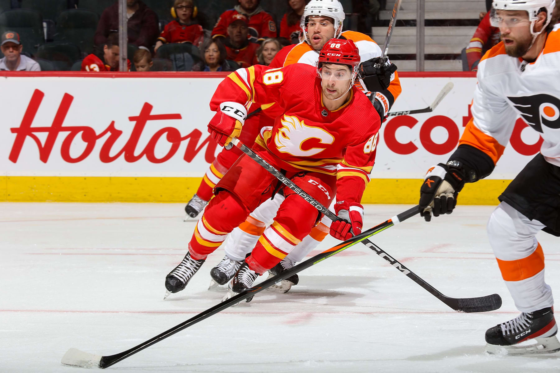 CALGARY, AB - FEBRUARY 20: Andrew Mangiapane #88 of the Calgary Flames battles against the Philadelphia Flyers at Scotiabank Saddledome on February 20, 2023 in Calgary, Alberta, Canada. (Photo by Gerry Thomas/NHLI via Getty Images)