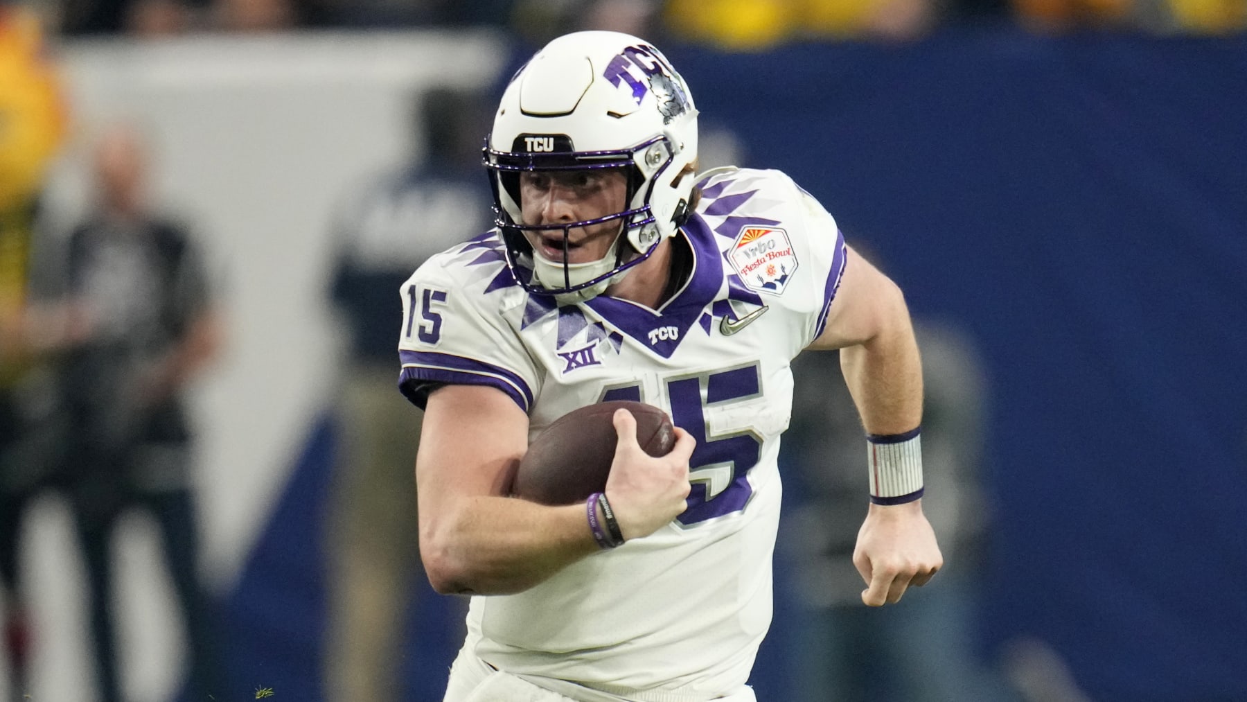 TCU quarterback Max Duggan (15) scrambles against Michigan during the first half of the Fiesta Bowl NCAA college football semifinal playoff game, Saturday, Dec. 31, 2022, in Glendale, Ariz. (AP Photo/Ross D. Franklin)