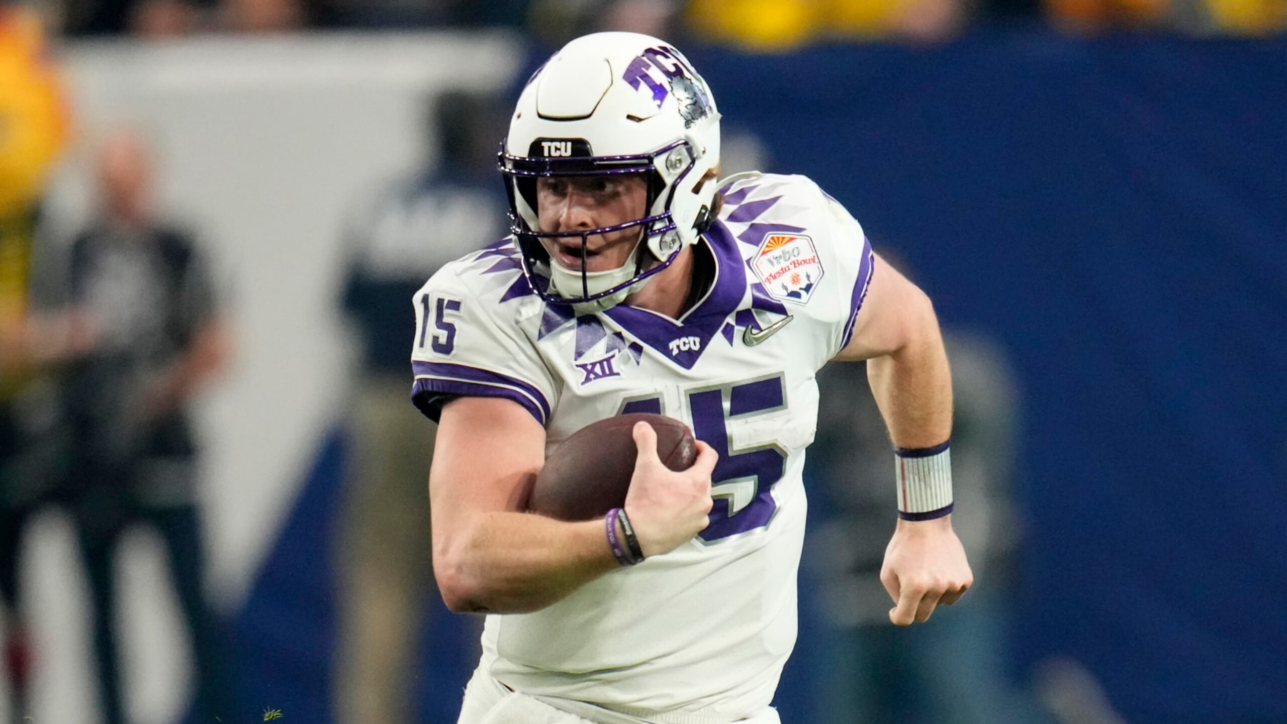 TCU quarterback Max Duggan (15) scrambles against Michigan during the first half of the Fiesta Bowl NCAA college football semifinal playoff game, Saturday, Dec. 31, 2022, in Glendale, Ariz. (AP Photo/Ross D. Franklin)