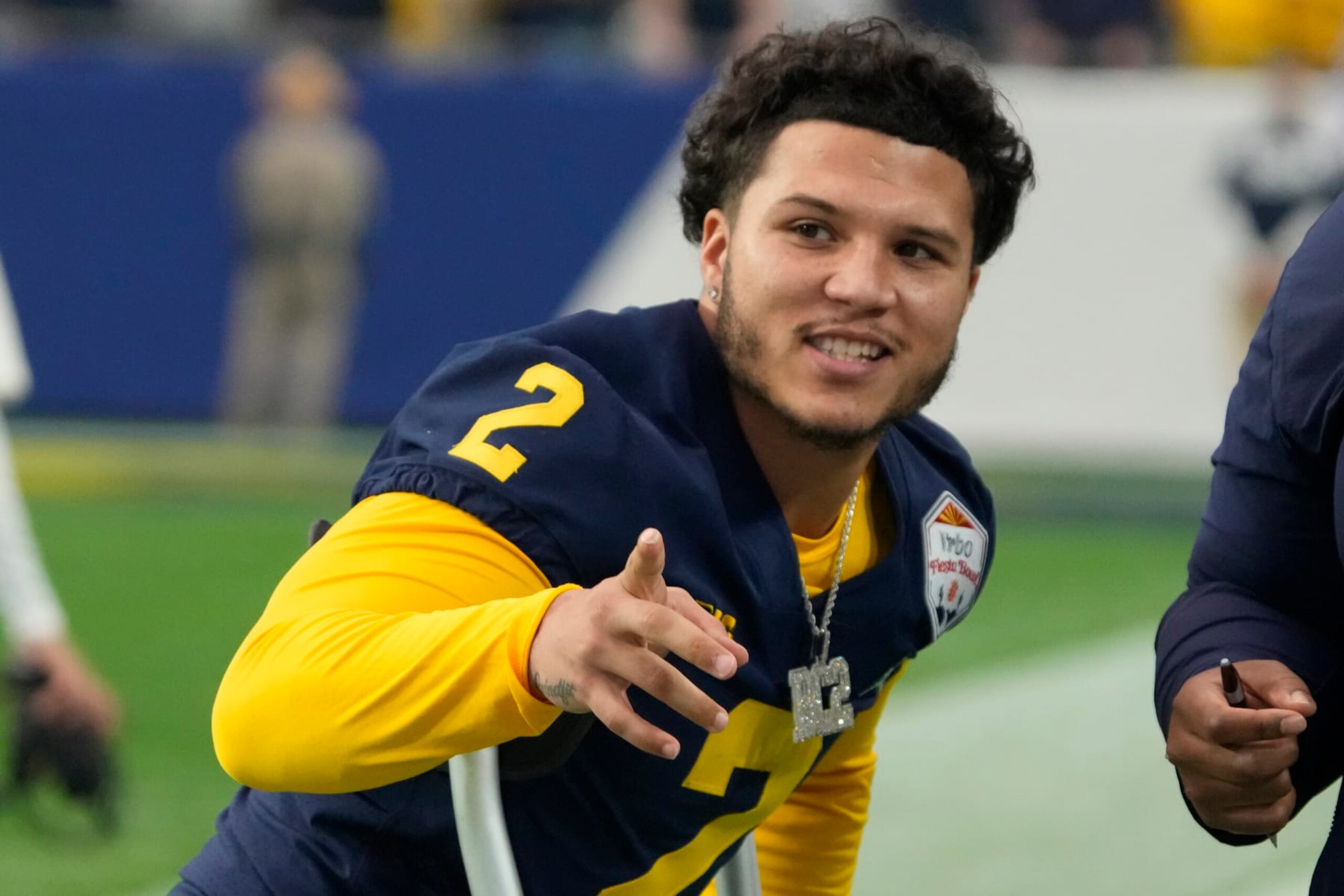FILE - Michigan running back Blake Corum (2) gestures during the first half of the Fiesta Bowl NCAA college football semifinal playoff game against TCU, Saturday, Dec. 31, 2022, in Glendale, Arizona. Michigan All-America running back Blake Corum reported his car stolen earlier this month in Ann Arbor. Corum's camouflage wrapped 2017 Camaro adorned with his BC2 logo was stolen from a parking garage between Jan. 13 and Jan. 16, according to Ann Arbor Police Department records.(AP Photo/Rick Scuteri, File)