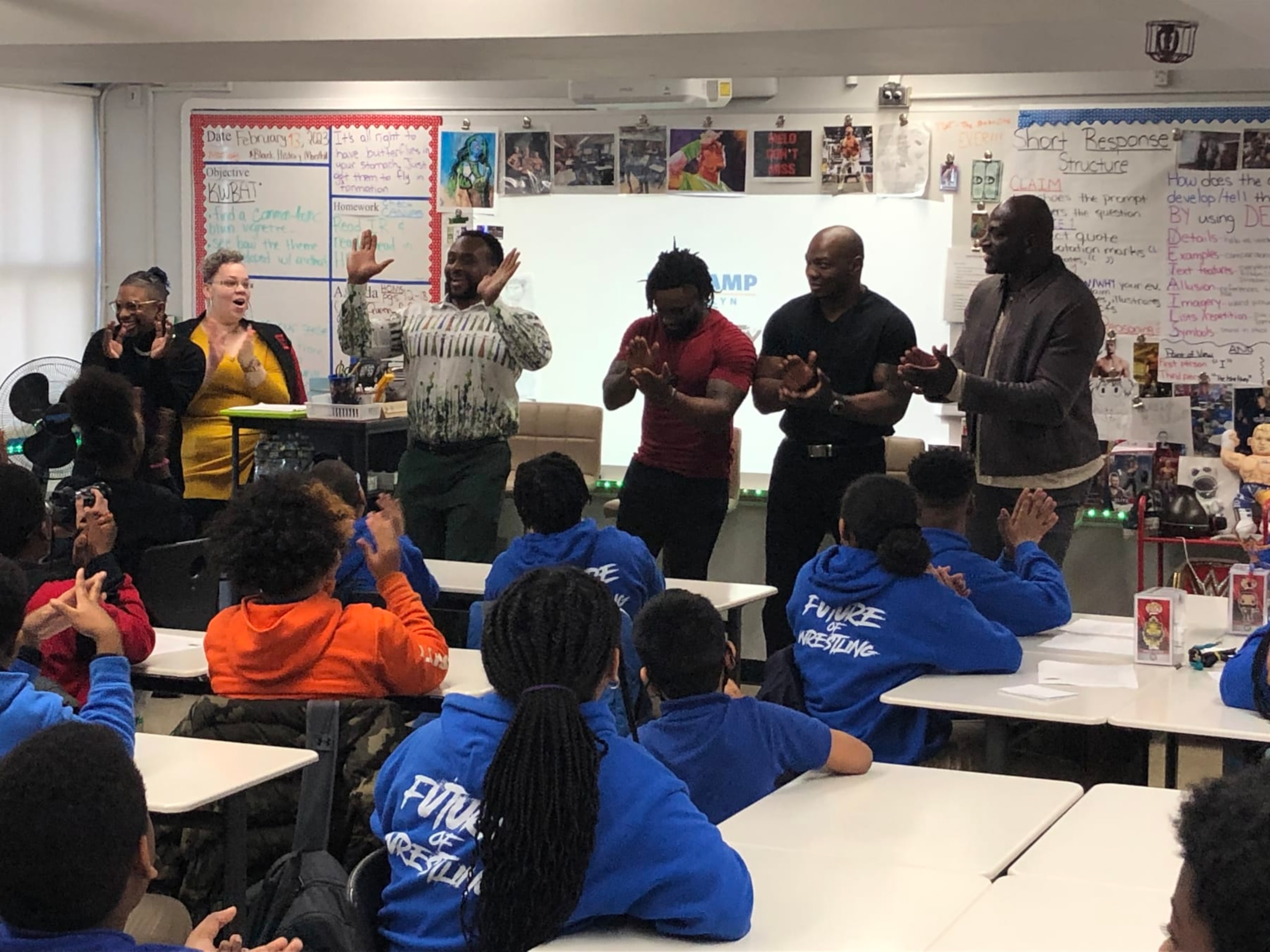 Victor Perry (far left) introduces WWE Superstars (from left) Big E, Cedric Alexander, Shelton Benjamin and Titus O'Neil to The Wrestling Club at KIPP AMP Middle School in Brooklyn, New York. (Feb. 13, 2023)