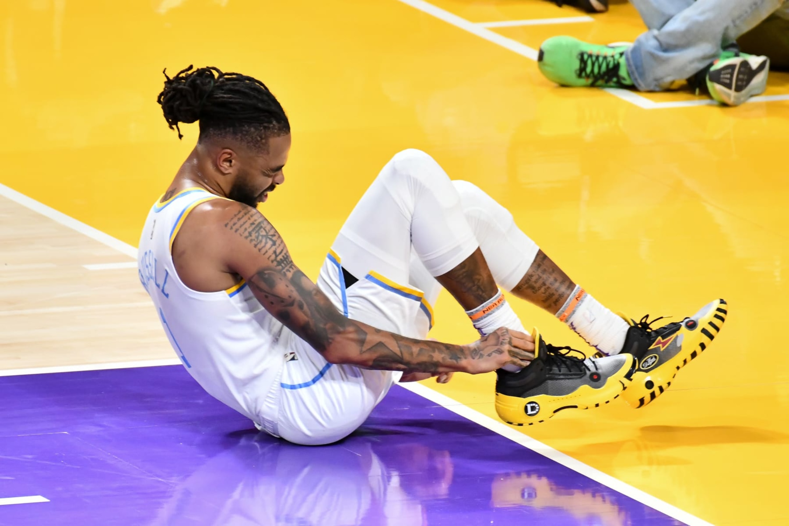 LOS ANGELES, CALIFORNIA - FEBRUARY 23: D'Angelo Russell #1 of the Los Angeles Lakers reacts after spraining his ankle in the first half against the Golden State Warriors at Crypto.com Arena on February 23, 2023 in Los Angeles, California. NOTE TO USER: User expressly acknowledges and agrees that,  by downloading and or using this photograph,  User is consenting to the terms and conditions of the Getty Images License Agreement. (Photo by Allen Berezovsky/Getty Images)