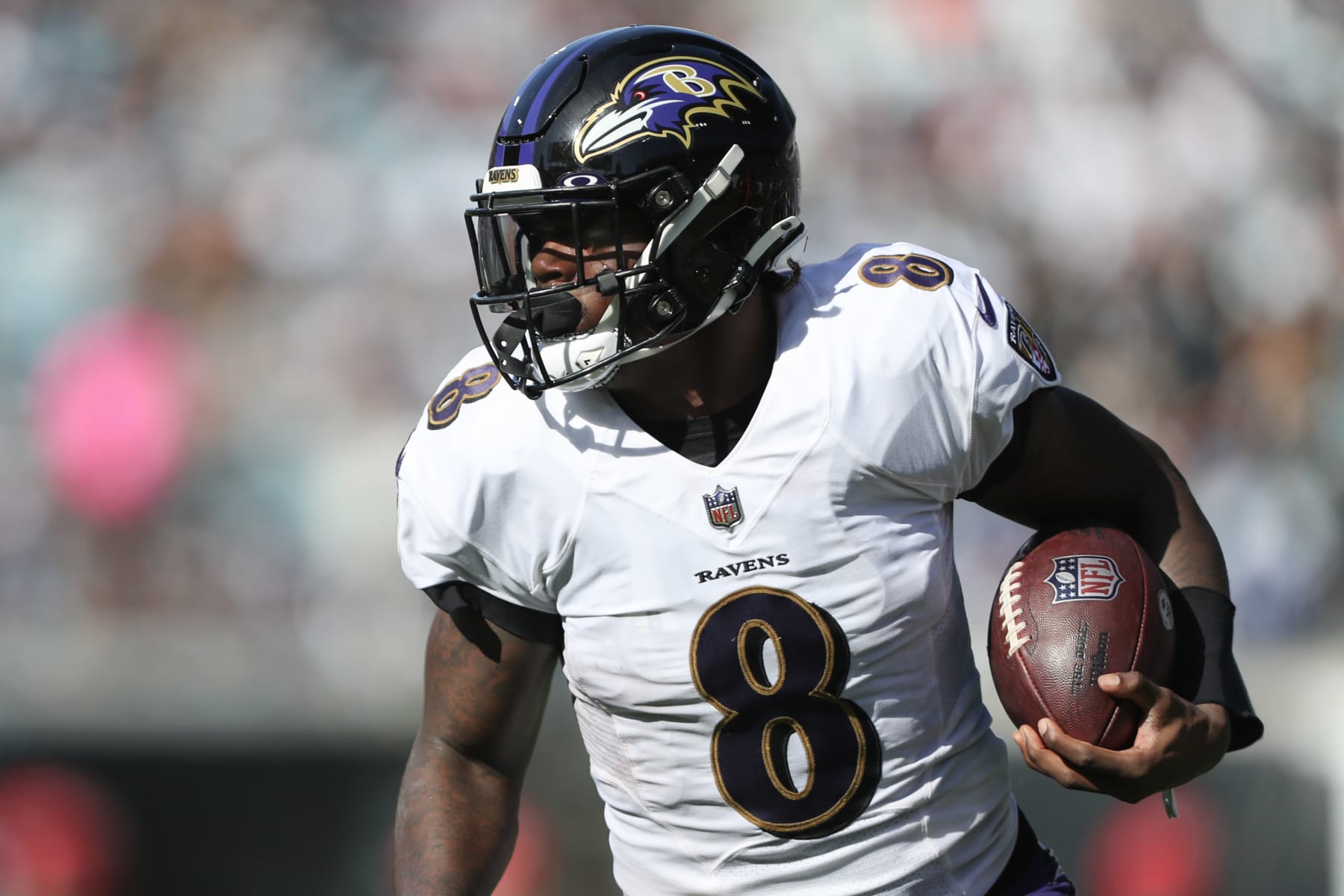 JACKSONVILLE, FLORIDA - NOVEMBER 27: Lamar Jackson #8 of the Baltimore Ravens carries the ball during the first half against the Jacksonville Jaguars at TIAA Bank Field on November 27, 2022 in Jacksonville, Florida. (Photo by Courtney Culbreath/Getty Images)