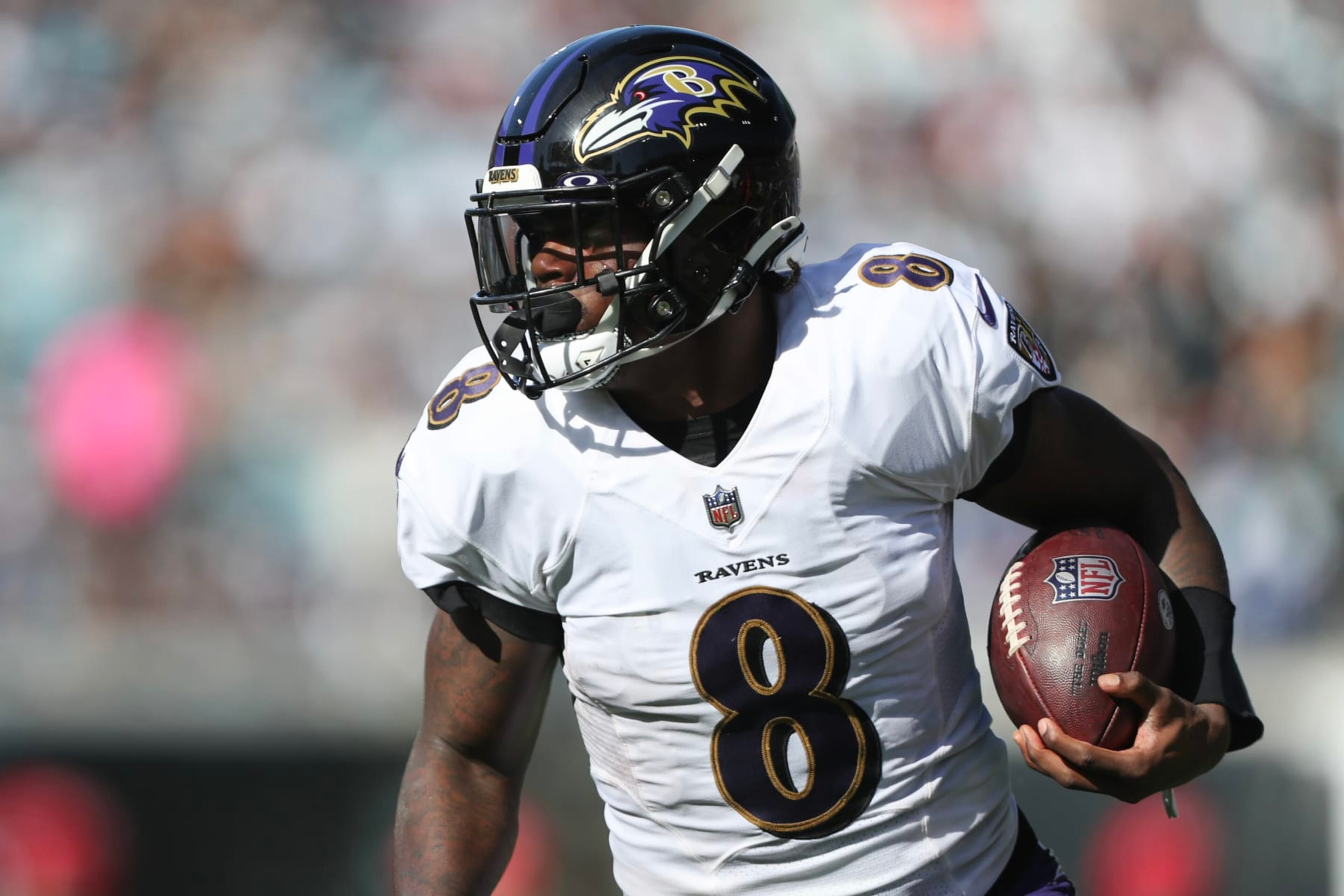 JACKSONVILLE, FLORIDA - NOVEMBER 27: Lamar Jackson #8 of the Baltimore Ravens carries the ball during the first half against the Jacksonville Jaguars at TIAA Bank Field on November 27, 2022 in Jacksonville, Florida. (Photo by Courtney Culbreath/Getty Images)