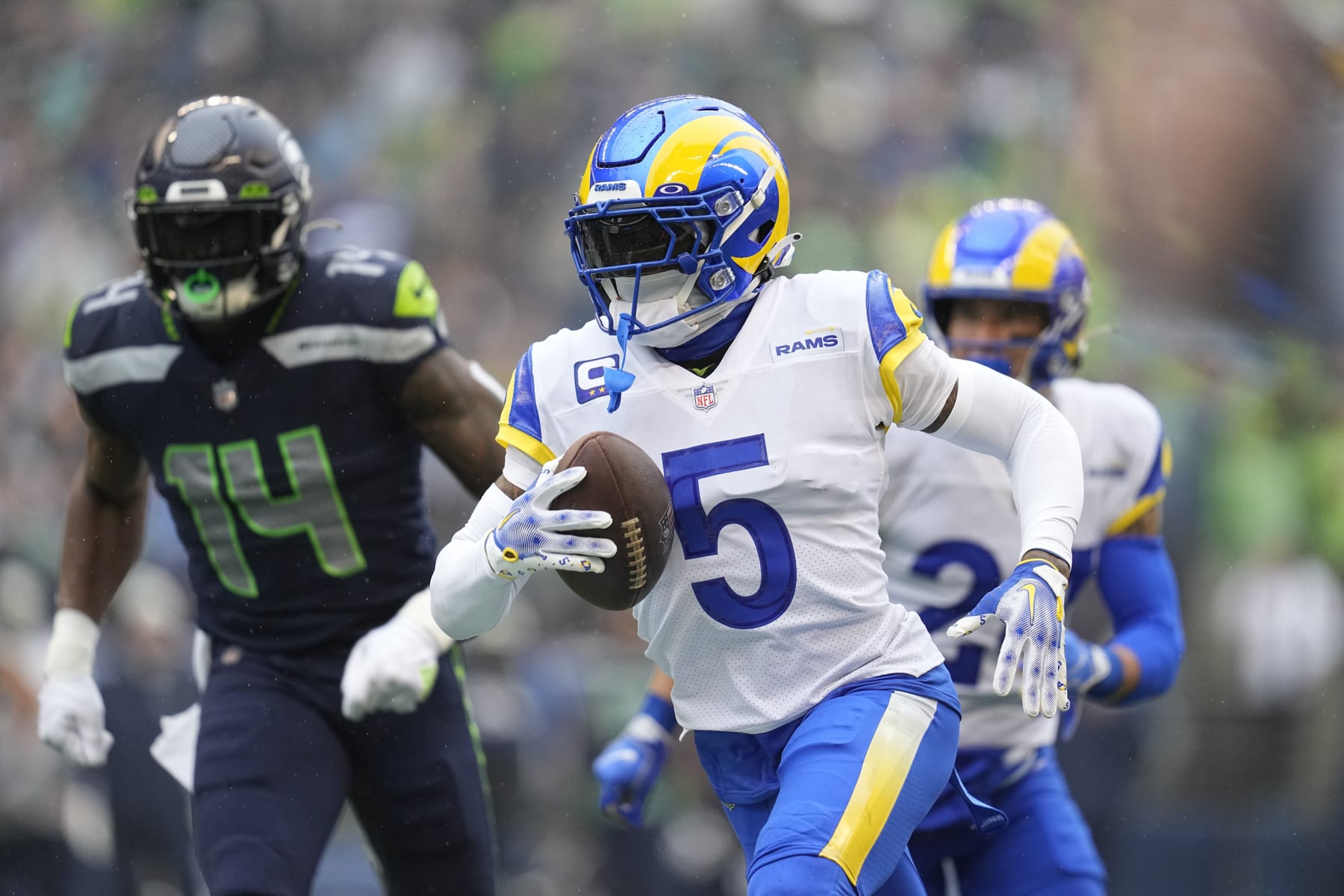 Los Angeles Rams cornerback Jalen Ramsey (5) runs with an intercepted pass past Seattle Seahawks wide receiver DK Metcalf (14) during the first half of an NFL football game Sunday, Jan. 8, 2023, in Seattle. (AP Photo/Abbie Parr)