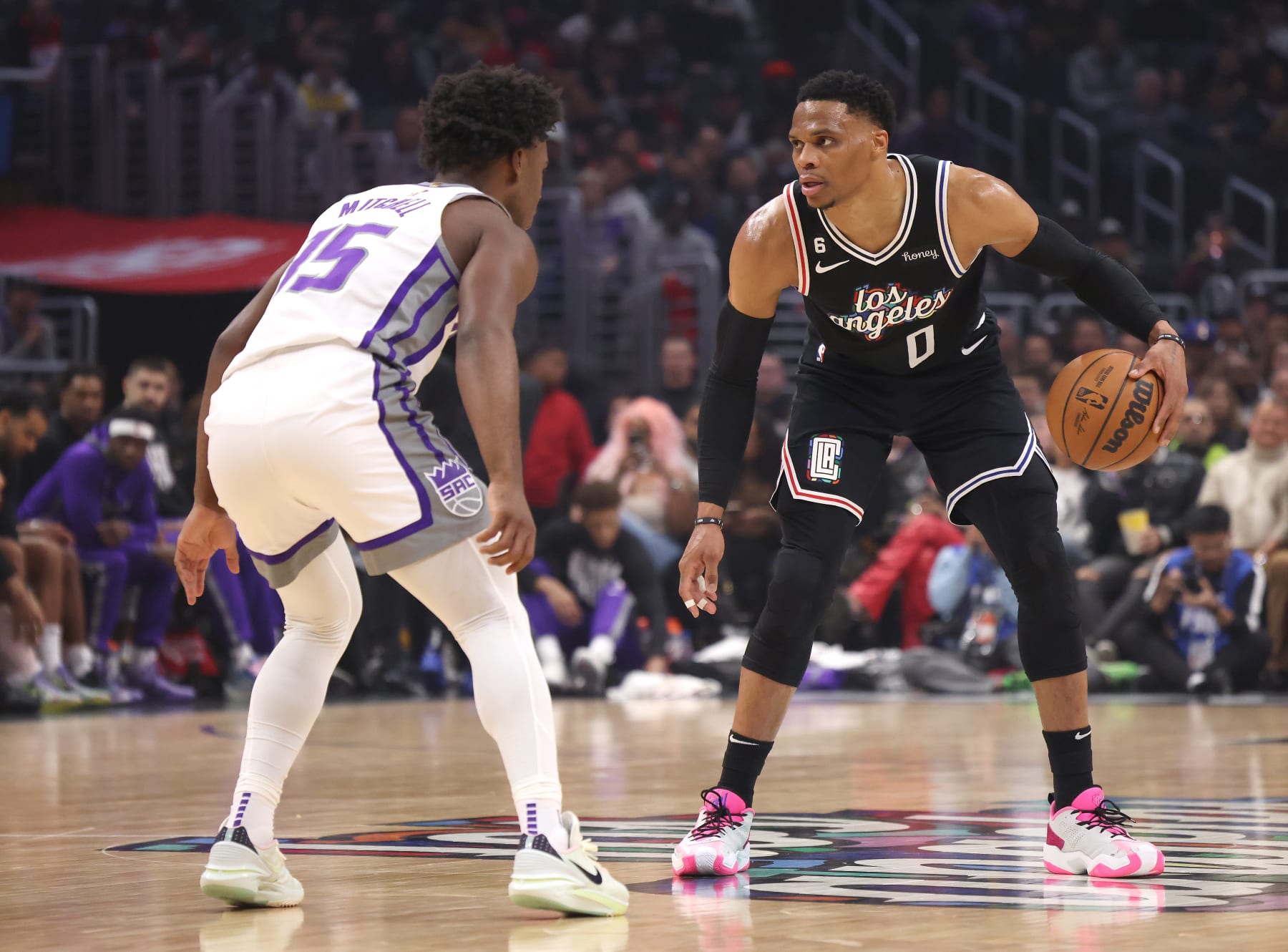 LOS ANGELES, CALIFORNIA - FEBRUARY 24: Russell Westbrook #0 of the LA Clippers dribbles in front of Davion Mitchell #15 of the Sacramento Kings during the first half at Crypto.com Arena on February 24, 2023 in Los Angeles, California. User is consenting to the terms and conditions of the Getty Images License Agreement. (Photo by Harry How/Getty Images)