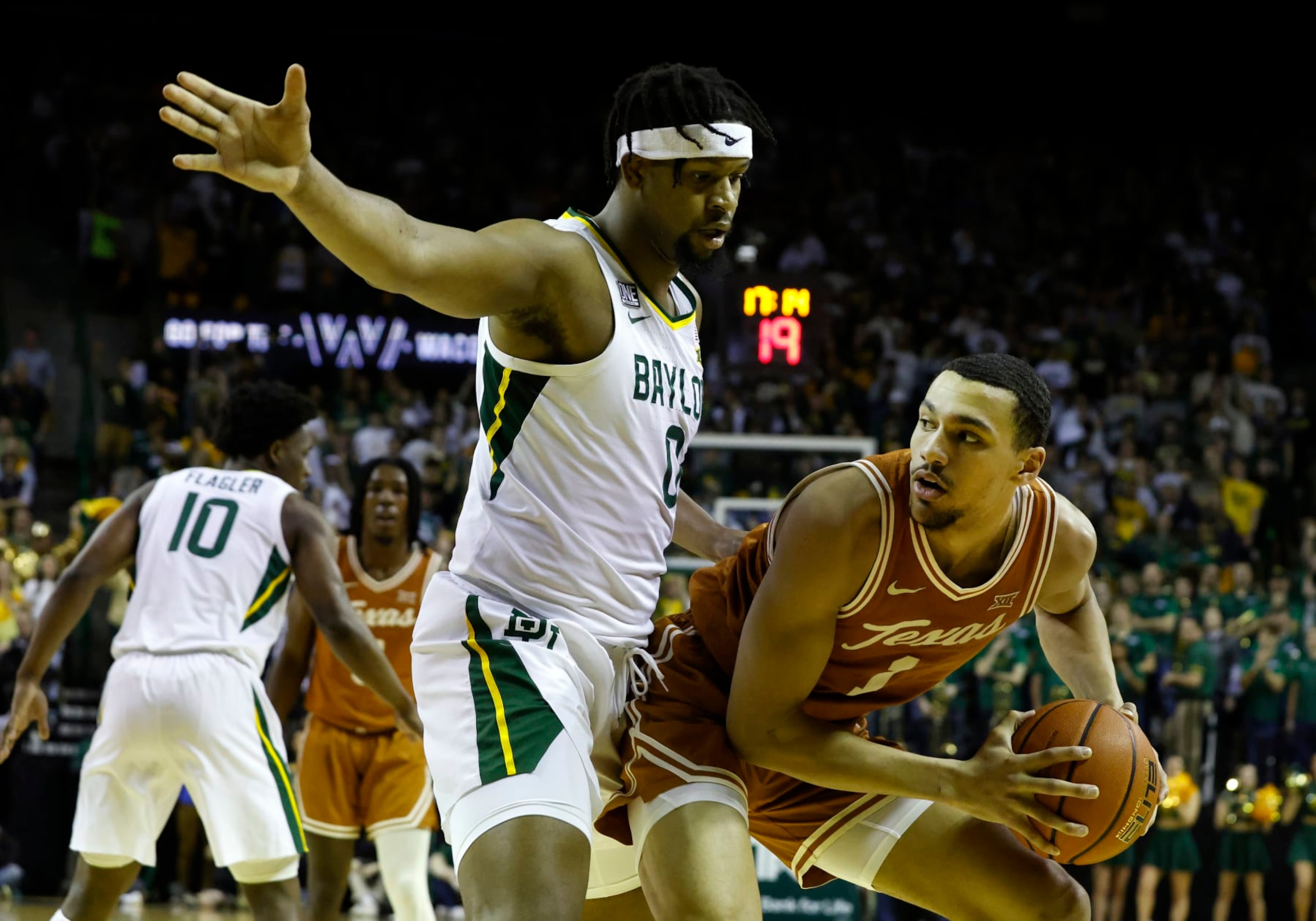WACO, TX - FEBRUARY 25: Texas Longhorns forward Dylan Disu (1) dribbles past Baylor Bears forward Flo Thamba (0) during the game at the Ferrell Center in Waco, TX on February 25, 2023. (Photo by Adam Davis/Icon Sportswire via Getty Images)