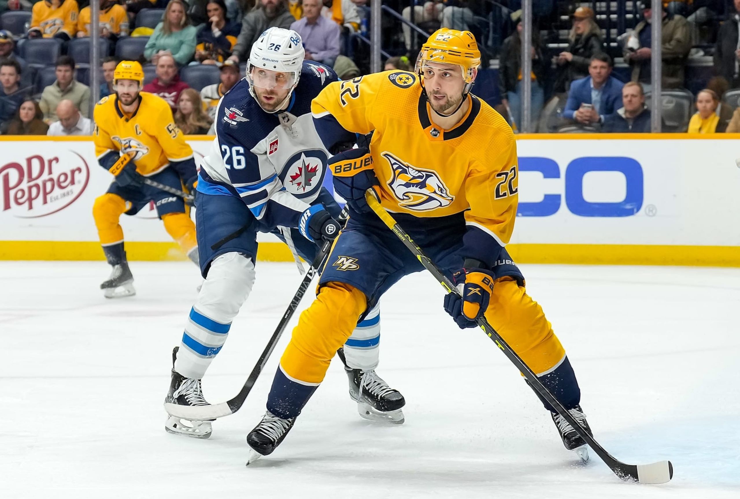 NASHVILLE, TENNESSEE - JANUARY 24: Nino Niederreiter #22 of the Nashville Predators skates against Blake Wheeler #26 of the Winnipeg Jets during an NHL game at Bridgestone Arena on January 24, 2023 in Nashville, Tennessee. (Photo by John Russell/NHLI via Getty Images)