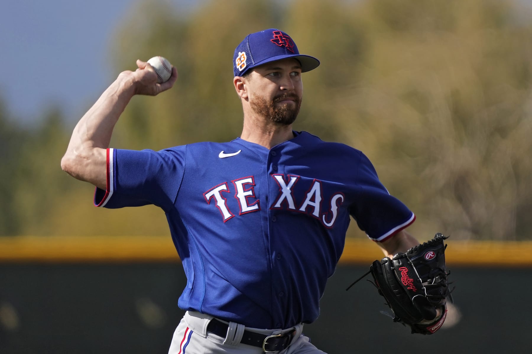 Texas Rangers pitcher Jacob deGrom throws during spring training baseball practice Sunday, Feb. 19, 2023, in Surprise, Ariz. (AP Photo/Charlie Riedel)