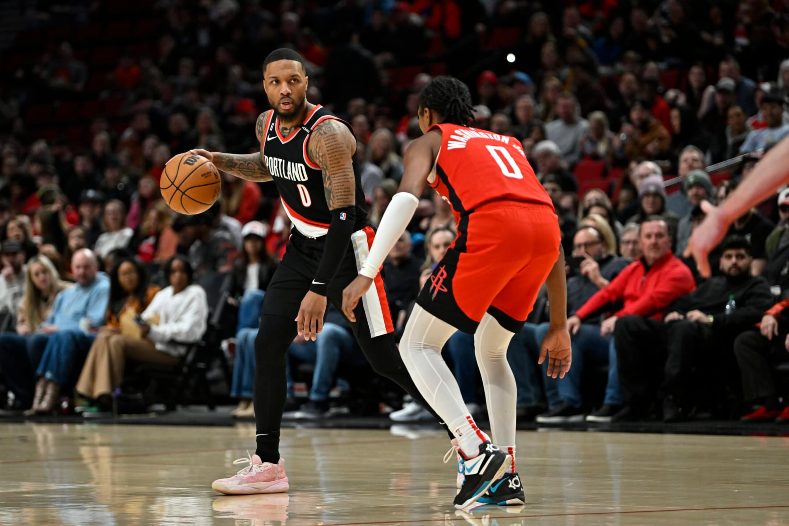 PORTLAND, OREGON - FEBRUARY 26: Damian Lillard #0 of the Portland Trail Blazers and TyTy Washington Jr. #0 of the Houston Rockets in action during the first quarter at the Moda Center on February 26, 2023 in Portland, Oregon. NOTE TO USER: User expressly acknowledges and agrees that, by downloading and or using this photograph, User is consenting to the terms and conditions of the Getty Images License Agreement. (Photo by Alika Jenner/Getty Images)