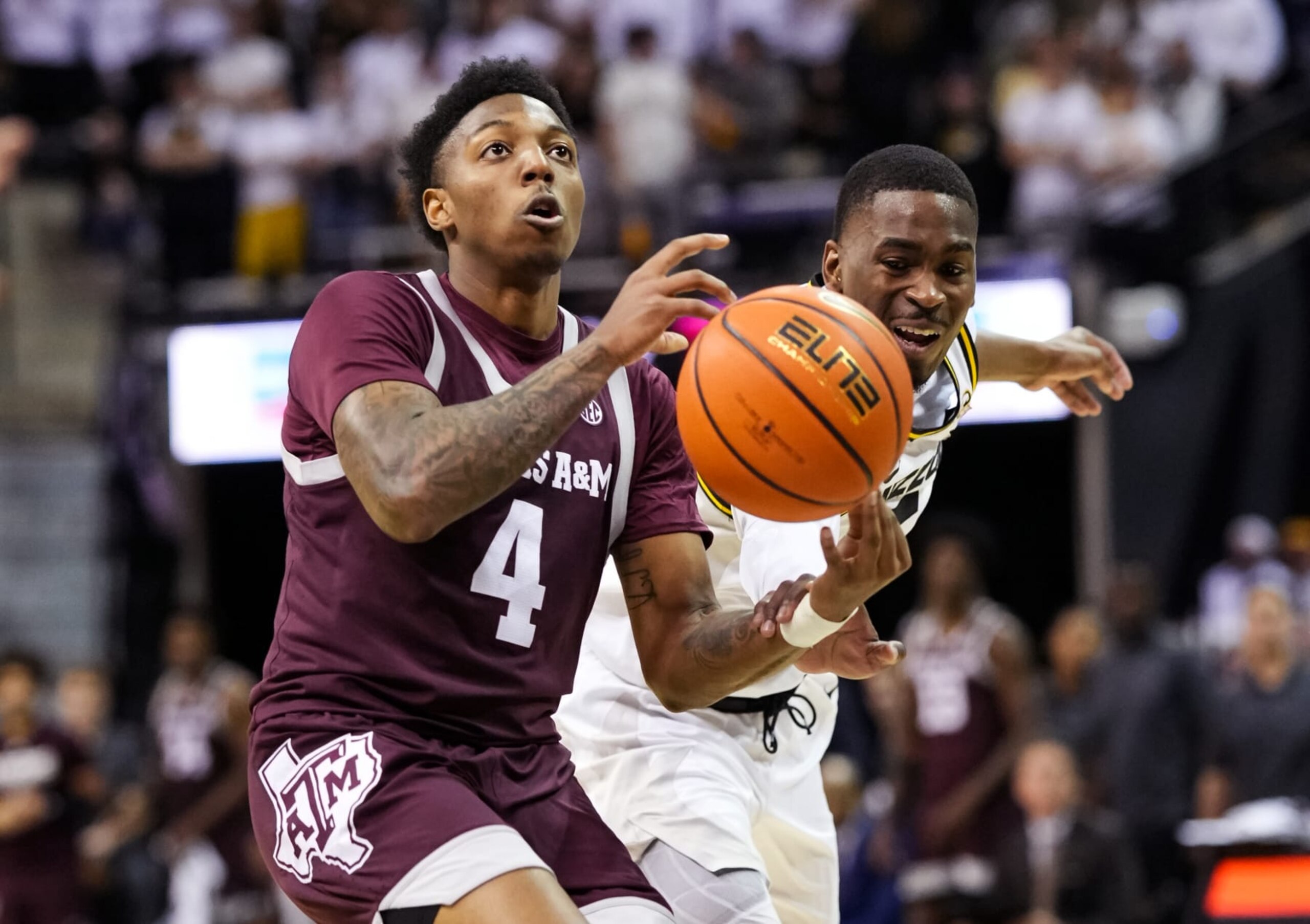 COLUMBIA, MO - FEBRUARY 18: Wade Taylor IV #4 of the Texas A&M Aggies is fouled by D'Moi Hodge #5 of the Missouri Tigers during the first half at Mizzou Arena on February 18, 2023 in Columbia, Missouri. (Photo by Jay Biggerstaff/Getty Images)