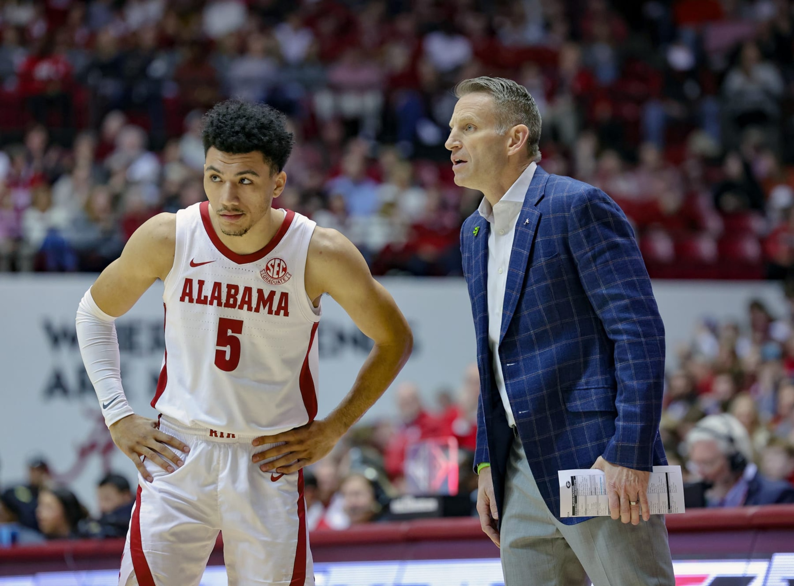 TUSCALOOSA, AL - FEBRUARY 18: Jahvon Quinerly #5 of the Alabama Crimson Tide gets first half instructions from head coach Nate Oats during a time out against the Georgia Bulldogs at Coleman Coliseum on February 18, 2023 in Tuscaloosa, Alabama. (Photo by Brandon Sumrall/Getty Images)