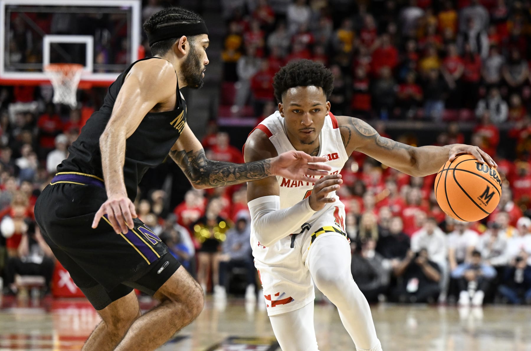 Jahmir Young dribbles by Boo Buie. 