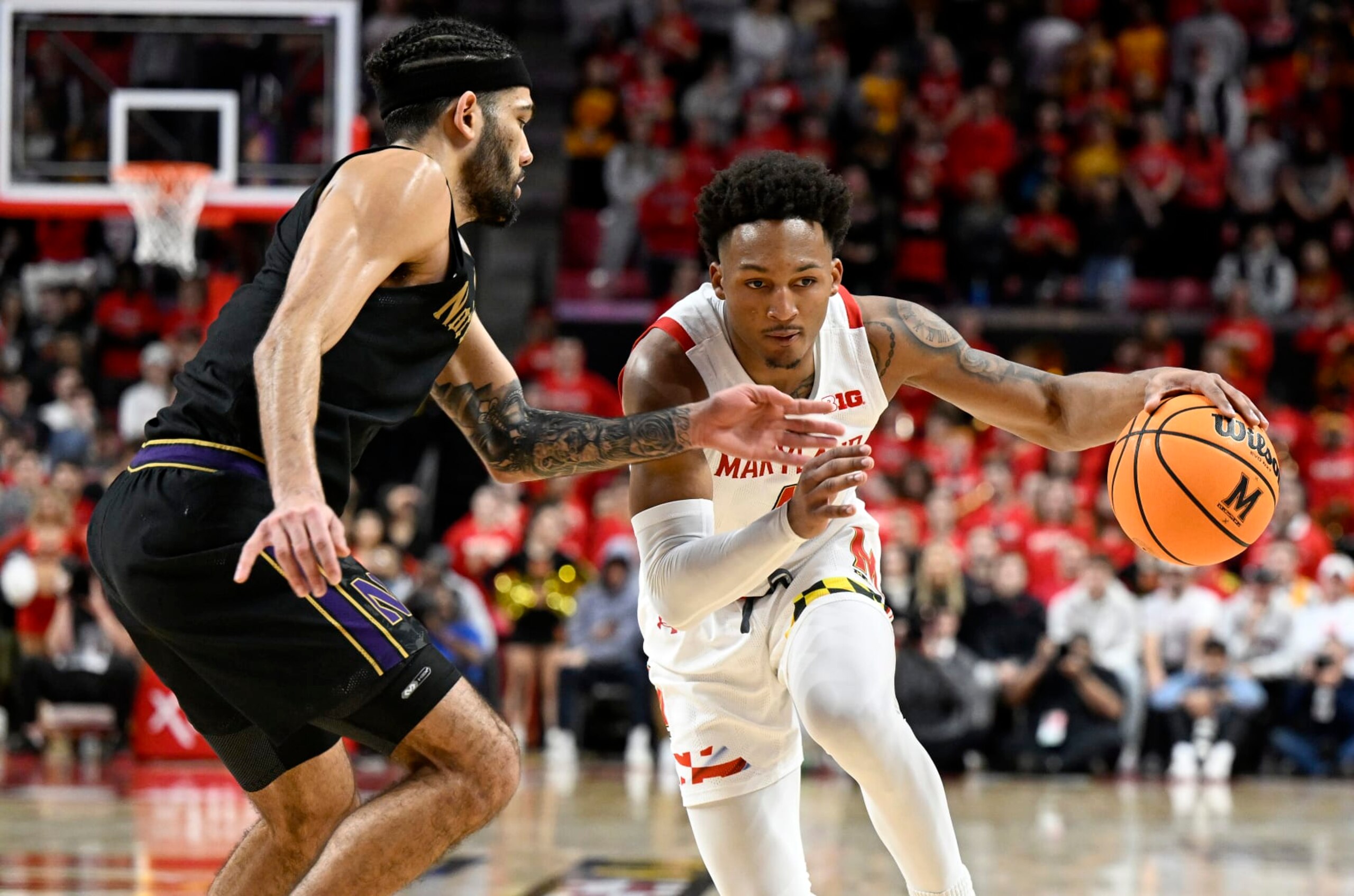 Jahmir Young dribbles by Boo Buie. 