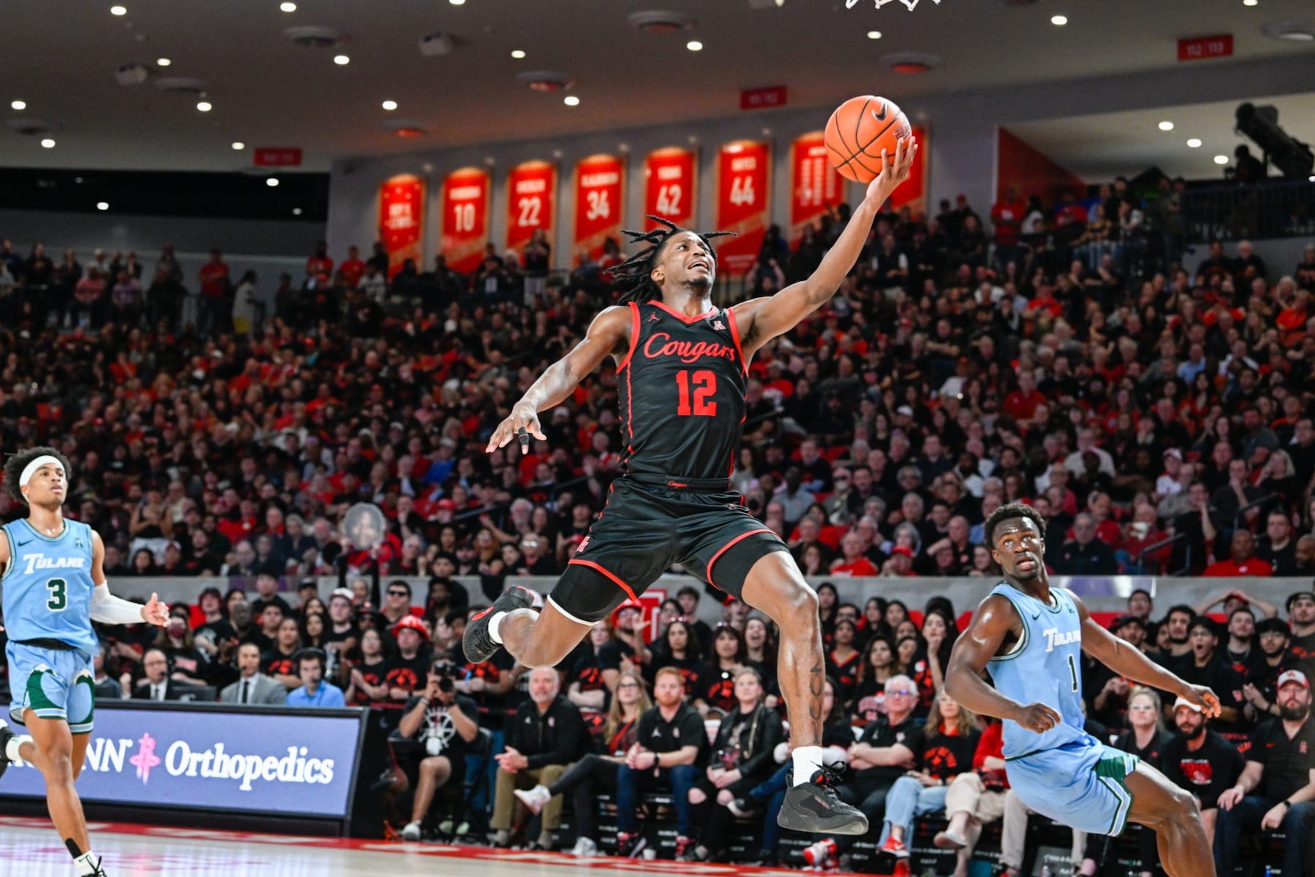 HOUSTON, TX - FEBRUARY 22: Houston Cougars guard Tramon Mark (12) finishes a lone coast-to-coast fast break layup during the basketball game between the Tulane Green Wave and Houston Cougars at the Fertitta Center on February 22, 2023 in Houston, Texas. (Photo by Ken Murray/Icon Sportswire via Getty Images)