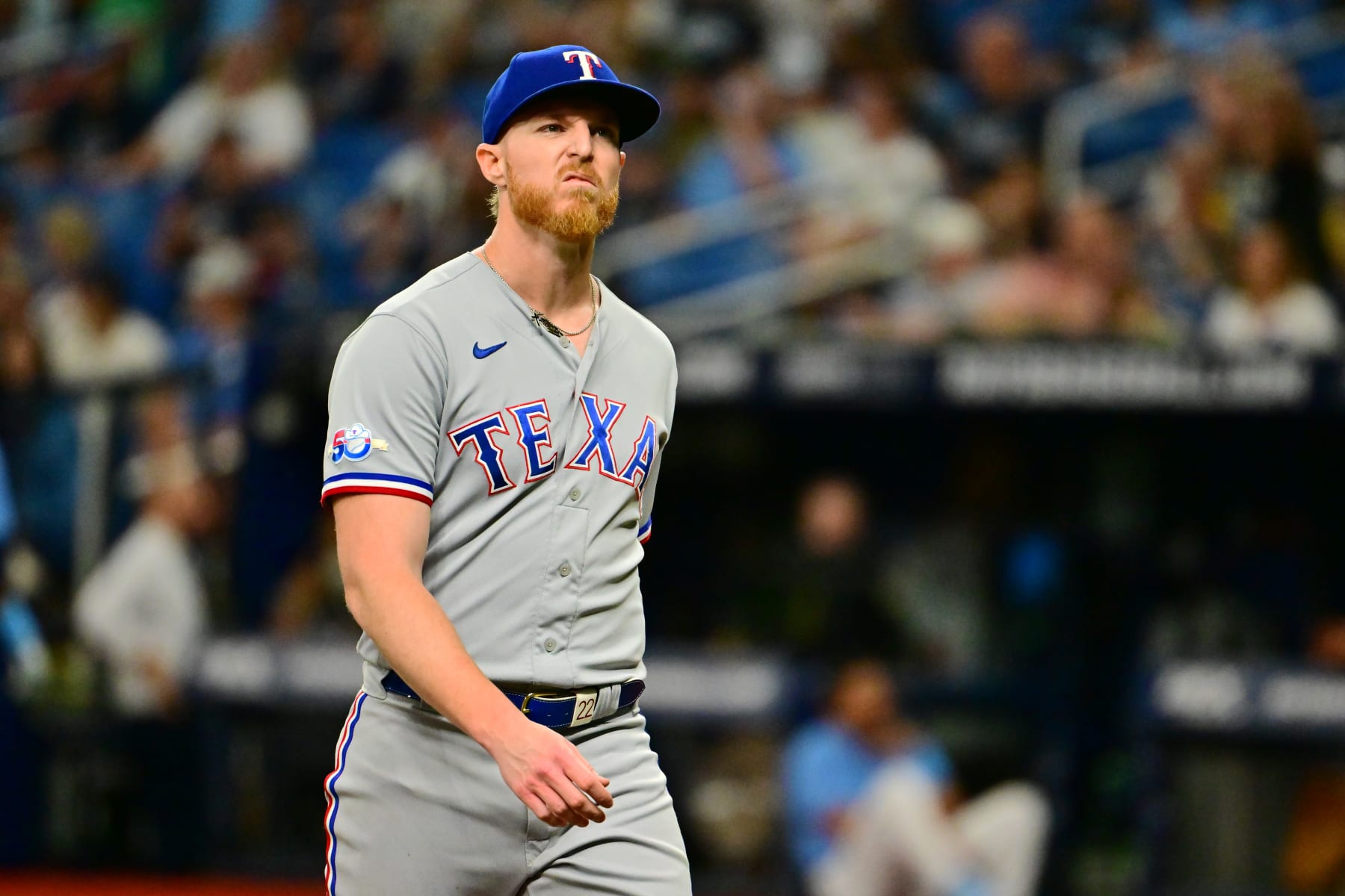 ST PETERSBURG, FLORIDA - SEPTEMBER 17: Jon Gray #22 of the Texas Rangers walks off the field following the second inning against the Tampa Bay Rays at Tropicana Field on September 17, 2022 in St Petersburg, Florida. (Photo by Julio Aguilar/Getty Images)