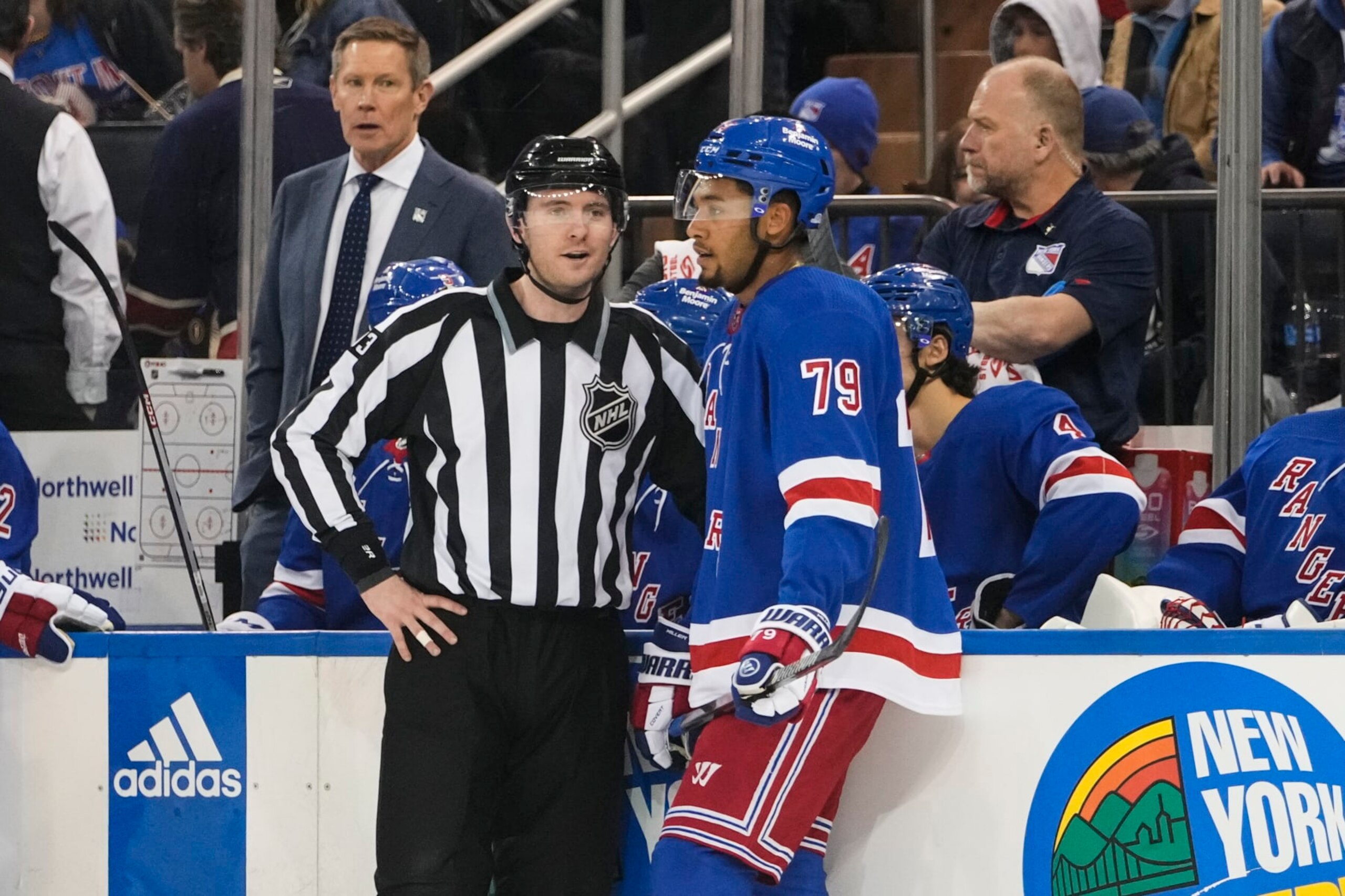 Linesman Kilian McNamara, left, talks to New York Rangers' K'Andre Miller (79) after Miller received a penalty during the first period of an NHL hockey game against the Los Angeles Kings, Sunday, Feb. 26, 2023, in New York. (AP Photo/Frank Franklin II)