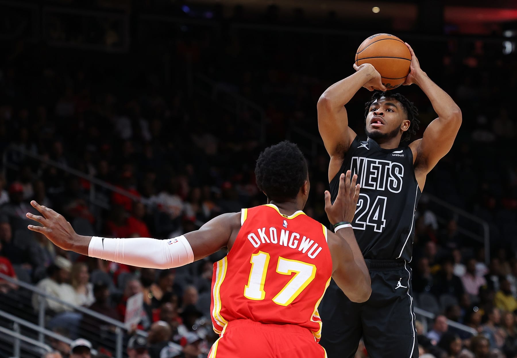 ATLANTA, GEORGIA - FEBRUARY 26:  Cam Thomas #24 of the Brooklyn Nets attempts a shot against Onyeka Okongwu #17 of the Atlanta Hawks during the first quarter at State Farm Arena on February 26, 2023 in Atlanta, Georgia.  NOTE TO USER: User expressly acknowledges and agrees that, by downloading and or using this photograph, User is consenting to the terms and conditions of the Getty Images License Agreement.  (Photo by Kevin C. Cox/Getty Images)