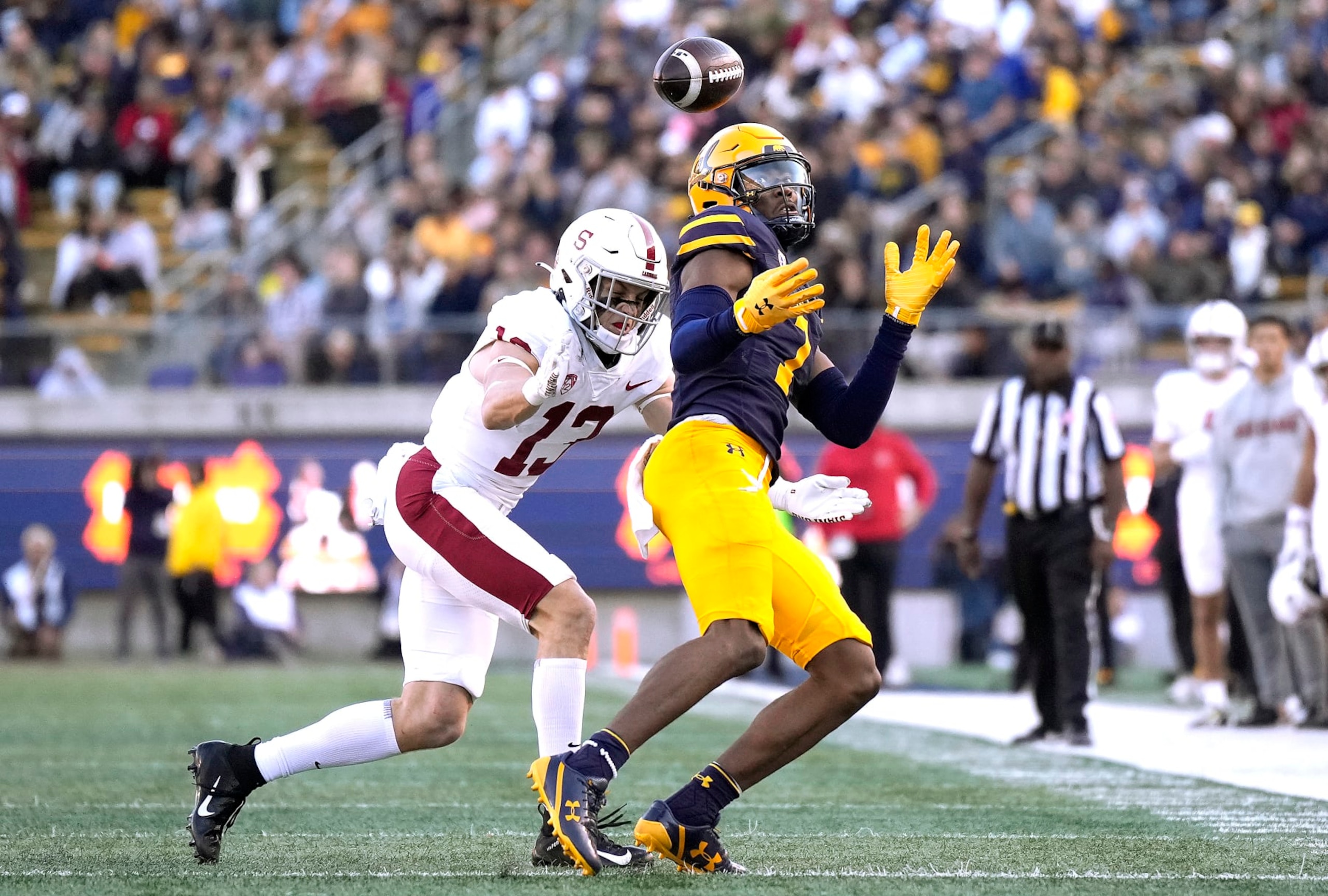 BERKELEY, CALIFORNIA - NOVEMBER 19: J. Michael Sturdivant #7 of the California Golden Bears can't hold on to the pass while getting hit by Ethan Bonner #13 of the Stanford Cardinal during the second quarter at California Memorial Stadium on November 19, 2022 in Berkeley, California. (Photo by Thearon W. Henderson/Getty Images)