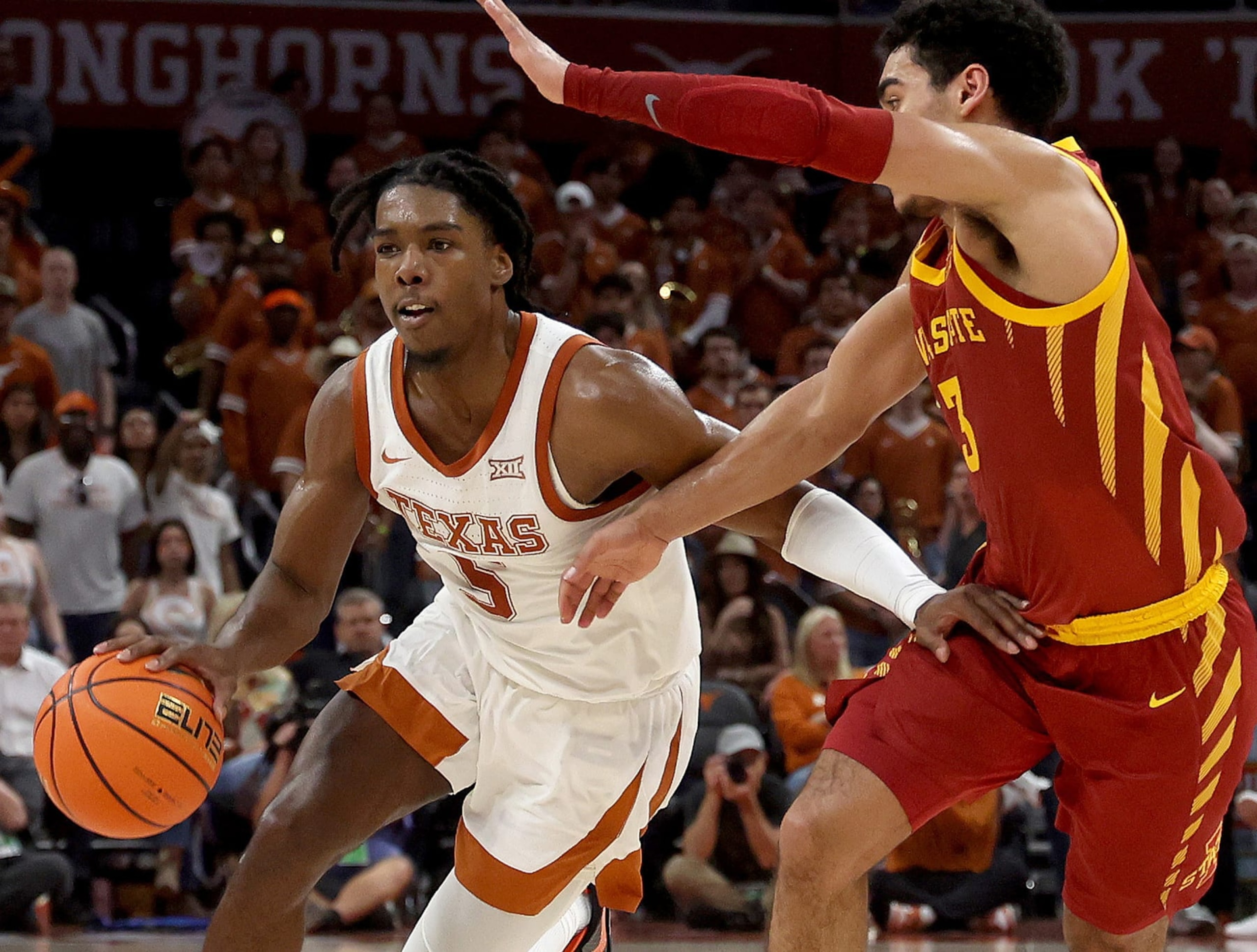 AUSTIN, TEXAS - FEBRUARY 21: Marcus Carr #5 of the Texas Longhorns drives around Jaren Holmes #13 of the Iowa State Cyclones in the second half of the game at the Moody Center on February 21, 2023 in Austin, Texas. (Photo by Chris Covatta/Getty Images)
