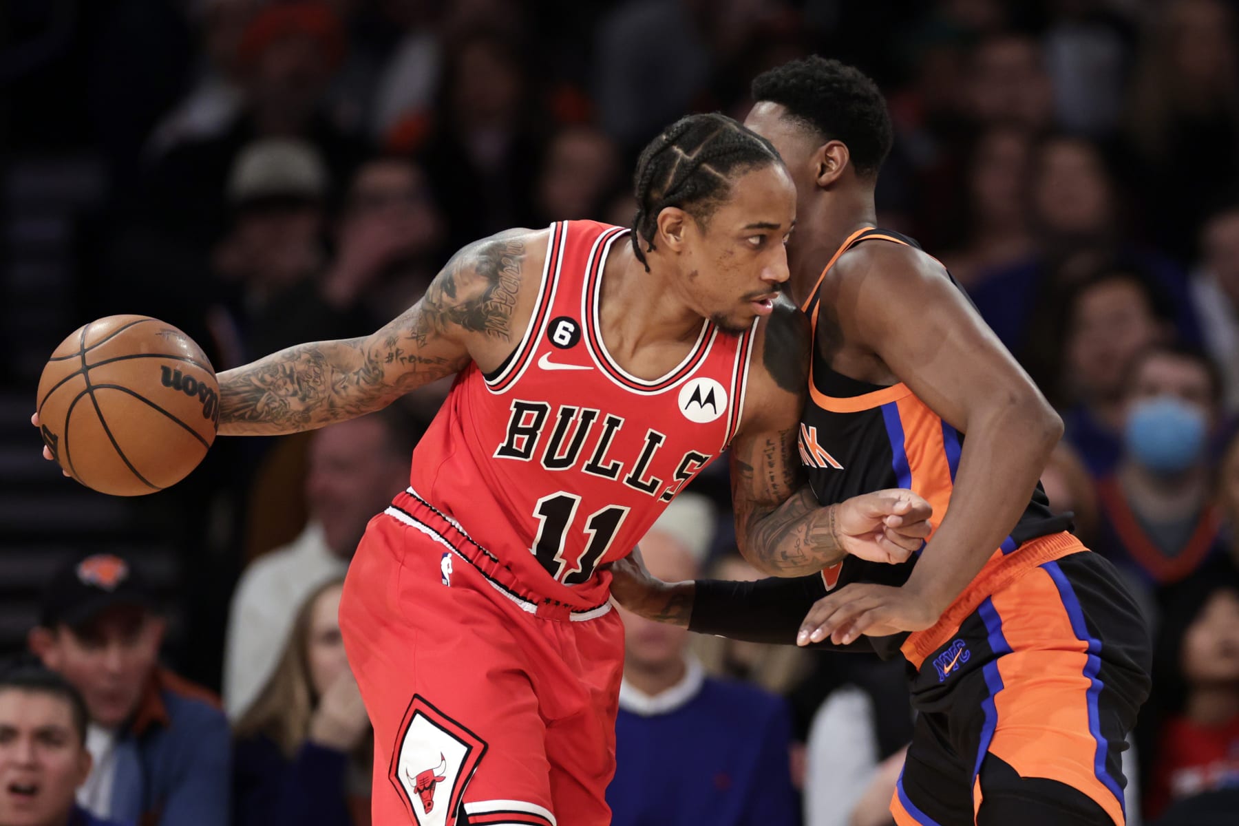 NEW YORK, NEW YORK - DECEMBER 23: DeMar DeRozan #11 of the Chicago Bulls drives to the basket against RJ Barrett #9 of the New York Knicks during the first half at Madison Square Garden on December 23, 2022 in New York City. NOTE TO USER: User expressly acknowledges and agrees that, by downloading and or using this Photograph, user is consenting to the terms and conditions of the Getty Images License Agreement.  (Photo by Adam Hunger/Getty Images)