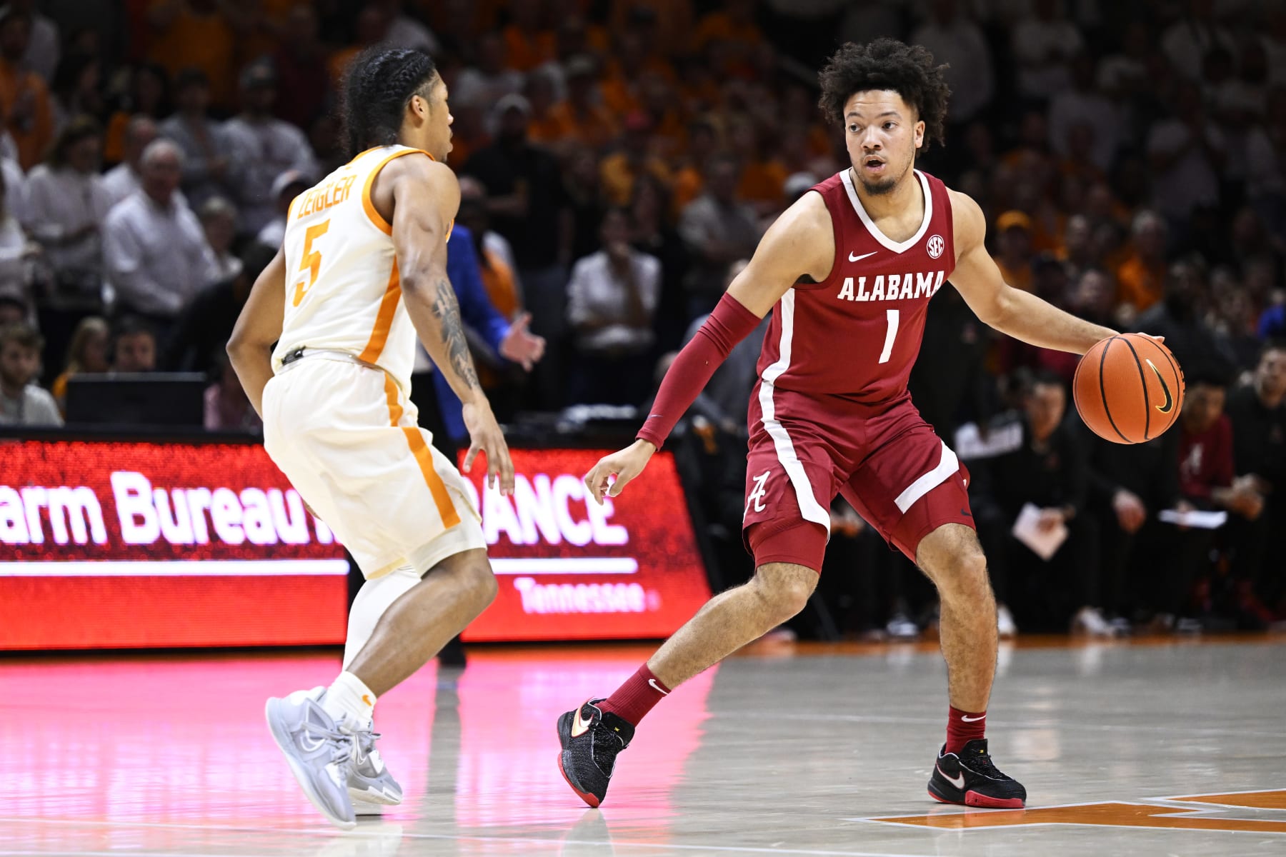 KNOXVILLE, TENNESSEE - FEBRUARY 15: Mark Sears #1 of the Alabama Crimson Tide dribbles against Zakai Zeigler #5 of the Tennessee Volunteers in the first half at Thompson-Boling Arena on February 15, 2023 in Knoxville, Tennessee. (Photo by Eakin Howard/Getty Images)
