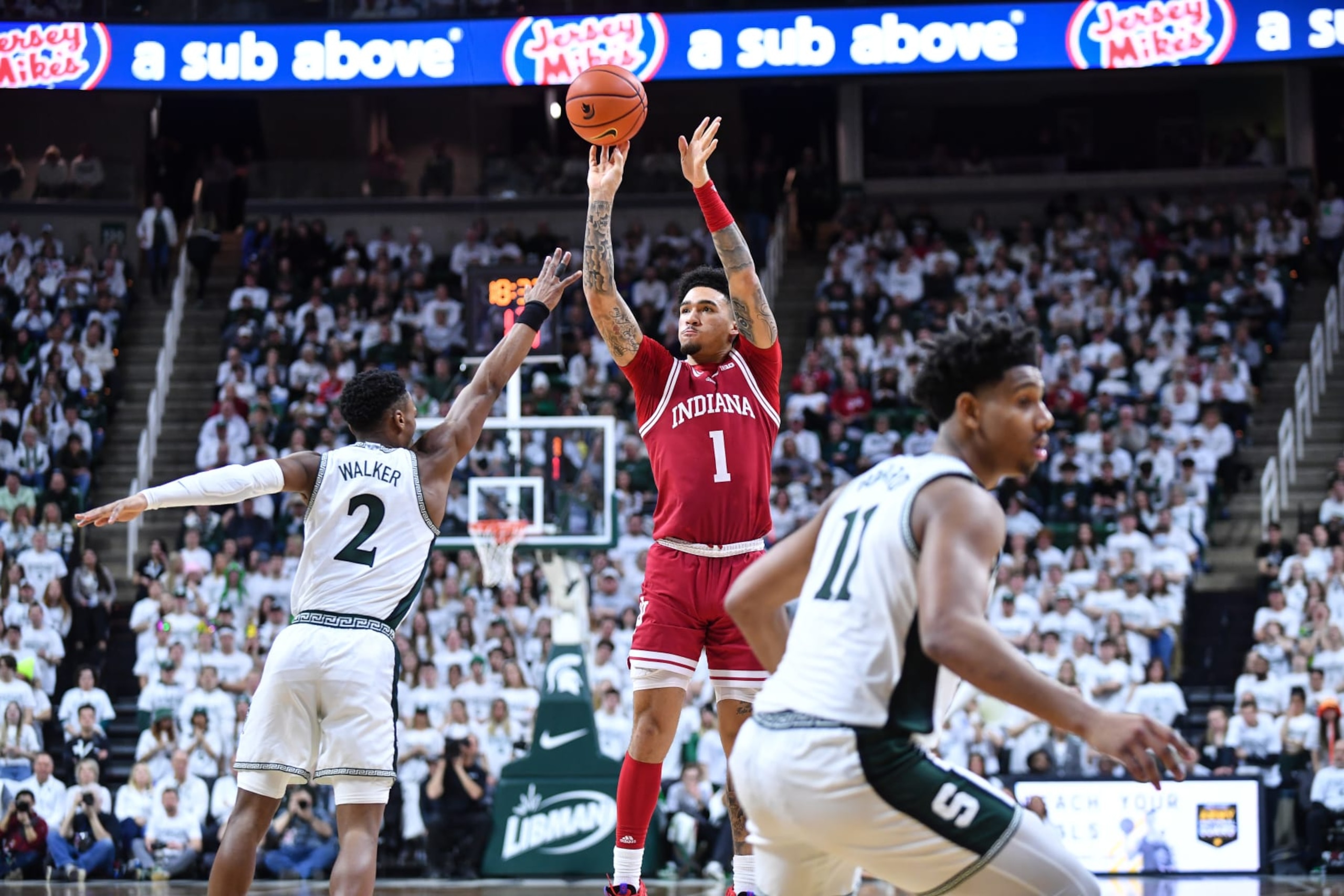 EAST LANSING, MI - FEBRUARY 21: Indiana Hoosiers guard Jalen Hood-Schifino (1) launches a three-point attempt over Michigan State Spartans guard Tyson Walker (2)  during a college basketball game between the Michigan State Spartans and Indiana Hoosiers on February 21, 2023 at the Breslin Center in East Lansing, MI. (Photo by Adam Ruff/Icon Sportswire via Getty Images)