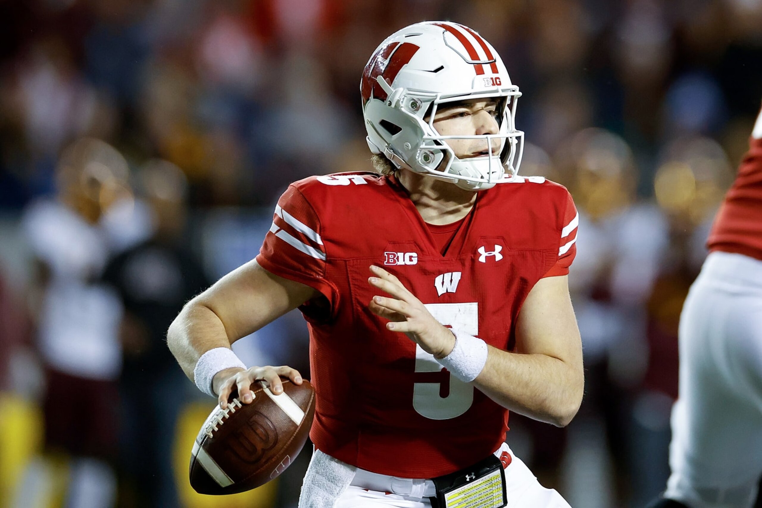 MADISON, WISCONSIN - NOVEMBER 26: Graham Mertz #5 of the Wisconsin Badgers drops back to pass during the second half of the game against the Minnesota Golden Gophers at Camp Randall Stadium on November 26, 2022 in Madison, Wisconsin. (Photo by John Fisher/Getty Images)