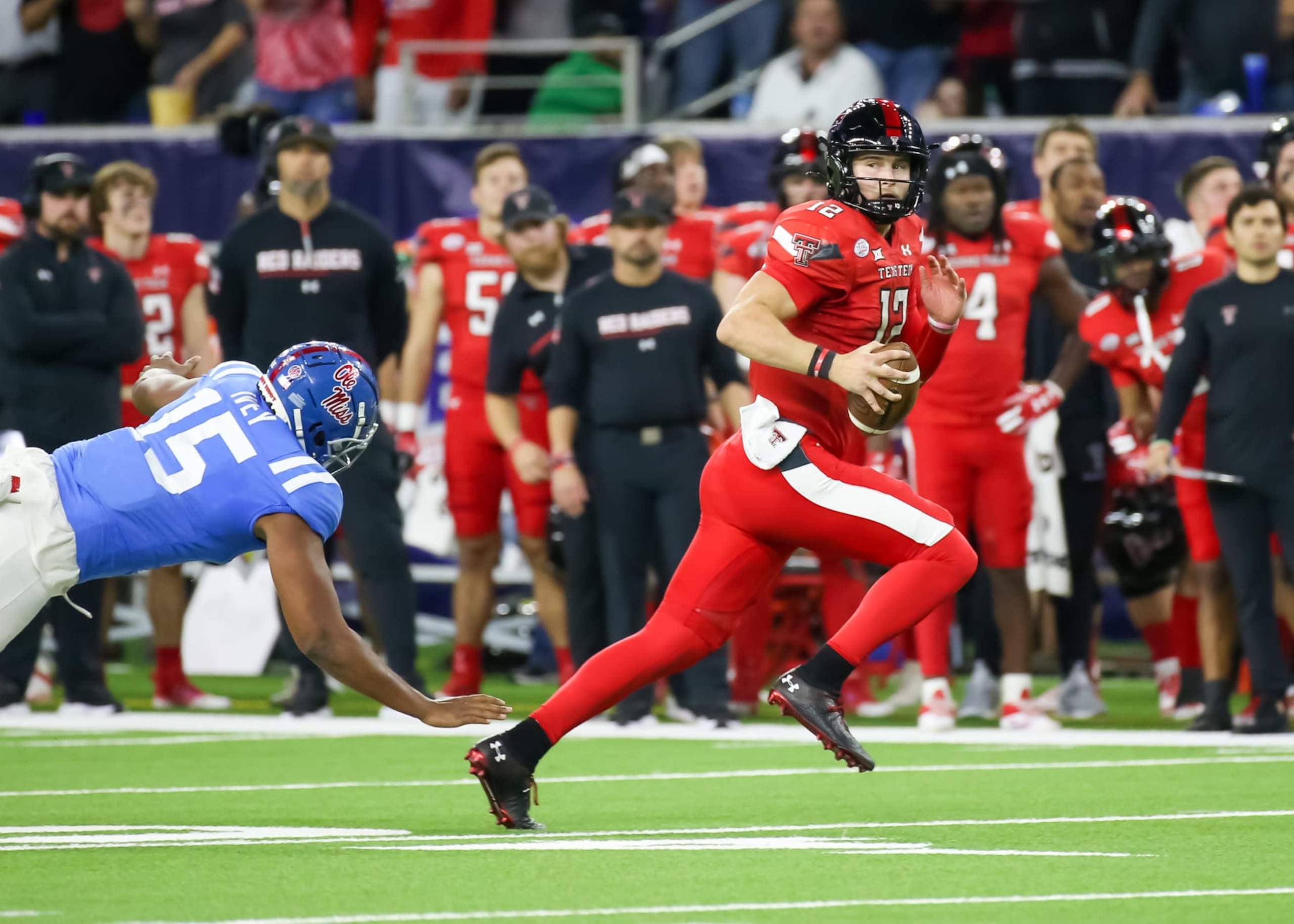 HOUSTON, TX - DECEMBER 28:  Texas Tech Red Raiders quarterback Tyler Shough (12) evades a tackle by Mississippi Rebels defensive end Jared Ivey (15) in the first quarter during the TaxAct Texas Bowl between the Texas Tech Red Raiders and Ole Miss Rebels on December 28, 2022 at NRG Stadium in Houston, Texas.  (Photo by Leslie Plaza Johnson/Icon Sportswire via Getty Images)