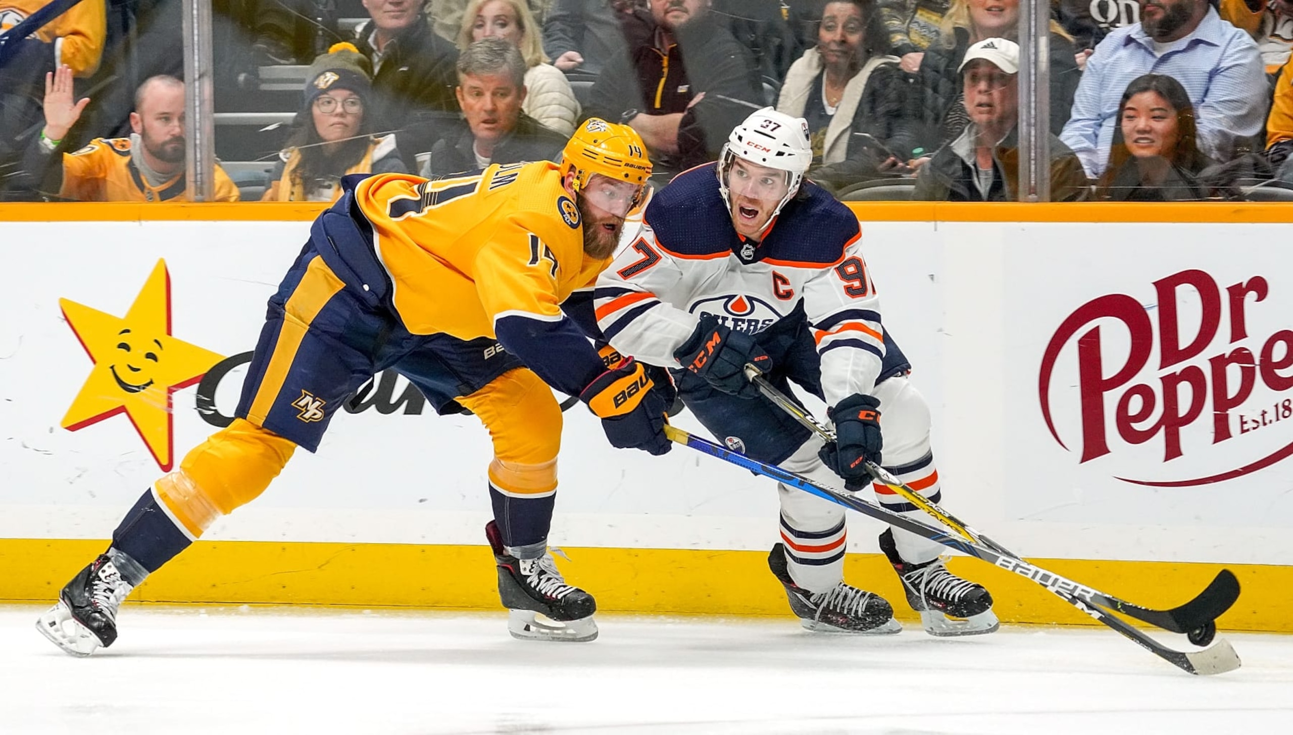 NASHVILLE, TN - MARCH 2: Mattias Ekholm #14 of the Nashville Predators battles for the puck against Connor McDavid #97 of the Edmonton Oilers at Bridgestone Arena on March 2, 2020 in Nashville, Tennessee. (Photo by John Russell/NHLI via Getty Images)