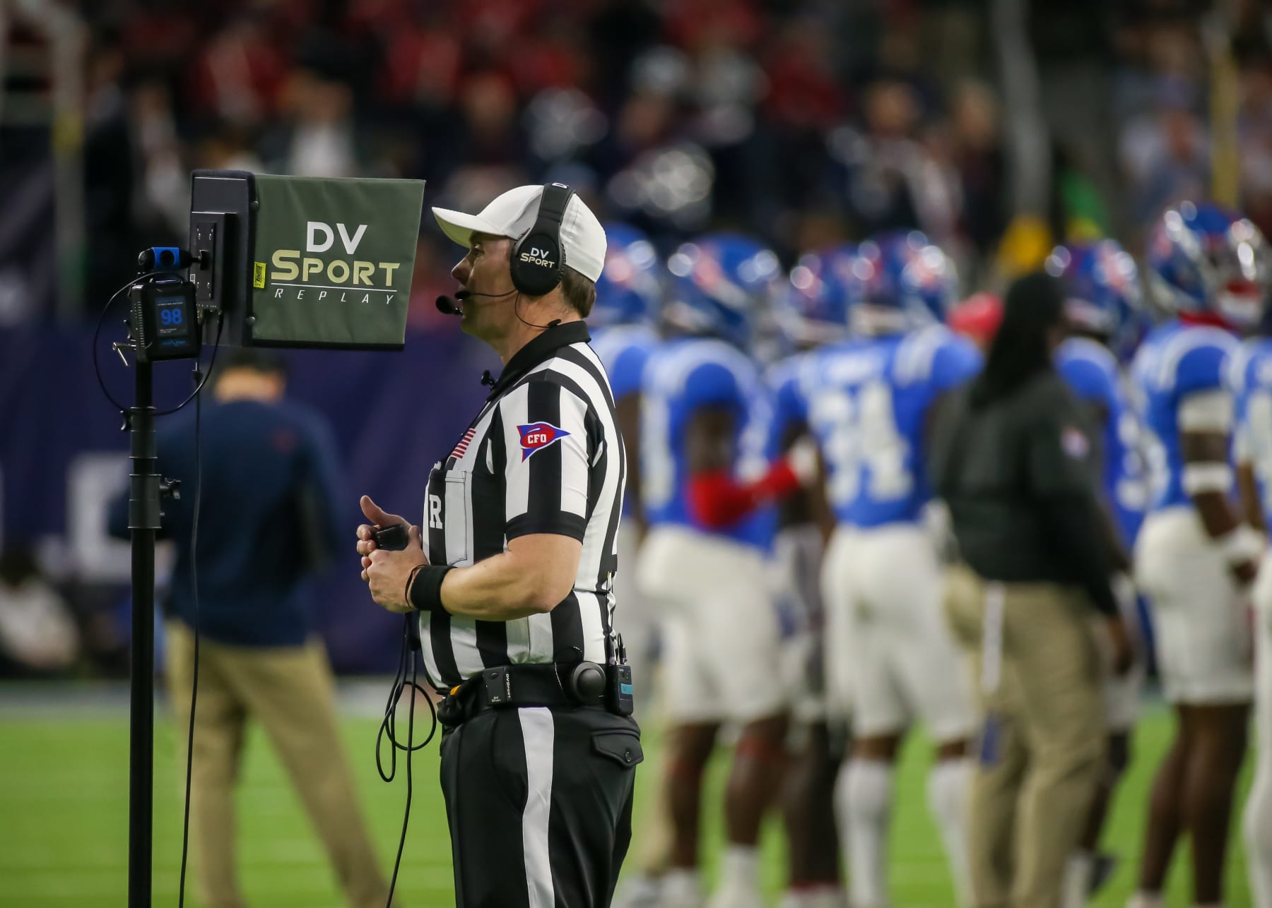 HOUSTON, TX - DECEMBER 28:  Referee Stuart Mullins reviews a play during the TaxAct Texas Bowl between the Texas Tech Red Raiders and Ole Miss Rebels on December 28, 2022 at NRG Stadium in Houston, Texas.  (Photo by Leslie Plaza Johnson/Icon Sportswire via Getty Images)