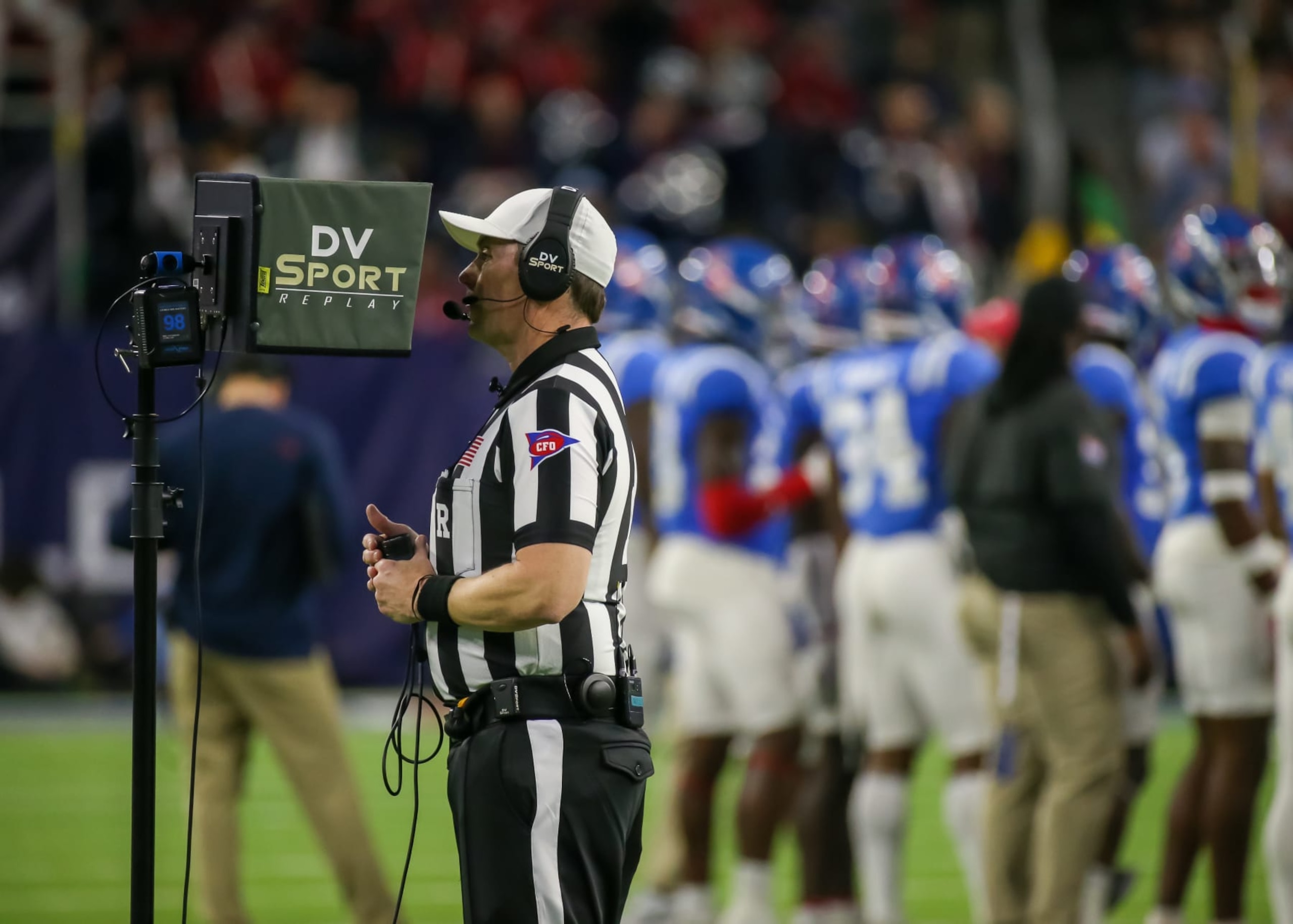 HOUSTON, TX - DECEMBER 28:  Referee Stuart Mullins reviews a play during the TaxAct Texas Bowl between the Texas Tech Red Raiders and Ole Miss Rebels on December 28, 2022 at NRG Stadium in Houston, Texas.  (Photo by Leslie Plaza Johnson/Icon Sportswire via Getty Images)