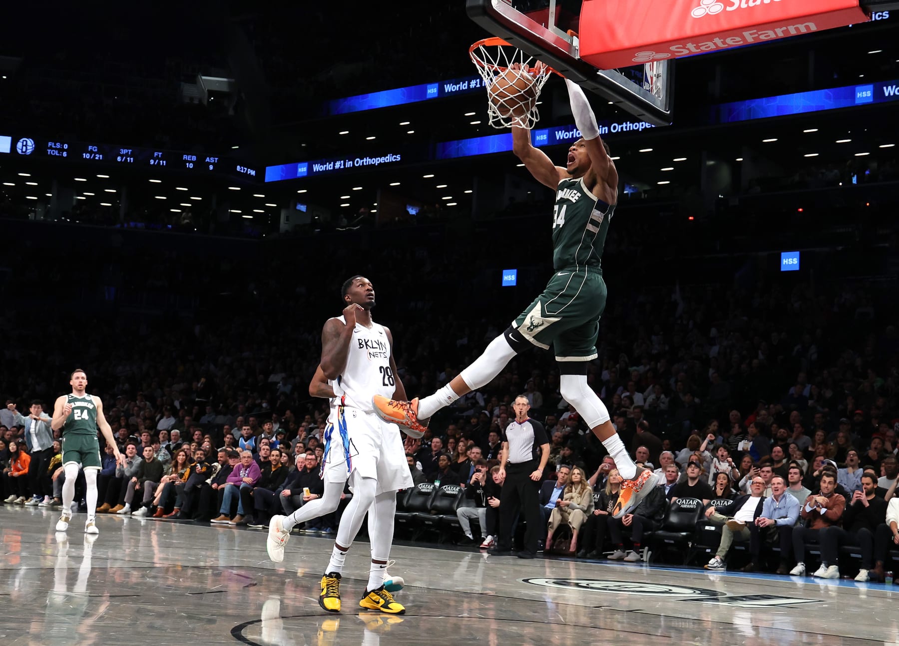 NEW YORK, NEW YORK - FEBRUARY 28:  Giannis Antetokounmpo #34 of the Milwaukee Bucks dunks against Dorian Finney-Smith #28 of the Brooklyn Nets during their game at Barclays Center on February 28, 2023 in New York City.  User expressly acknowledges and agrees that, by downloading and or using this photograph, User is consenting to the terms and conditions of the Getty Images License Agreement.   (Photo by Al Bello/Getty Images)