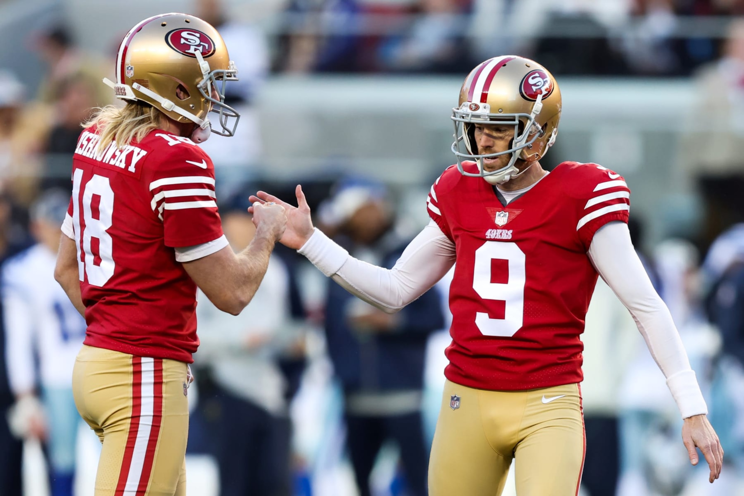 SANTA CLARA, CALIFORNIA - JANUARY 22: Mitch Wishnowsky #18 and Robbie Gould #9 of the San Francisco 49ers celebrate after a successful field goal against the Dallas Cowboys during the second quarter in the NFC Divisional Playoff game at Levi's Stadium on January 22, 2023 in Santa Clara, California. (Photo by Lachlan Cunningham/Getty Images)