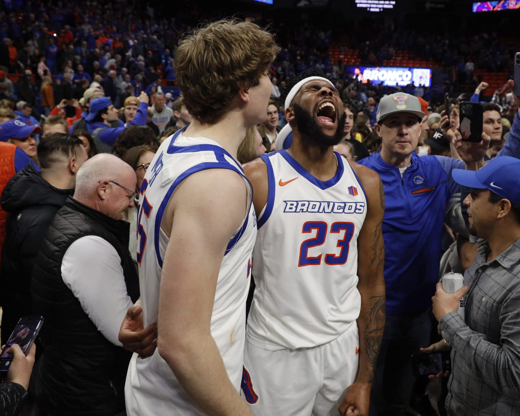 Boise State's Naje Smith (23) and Lukas Milner celebrate their win over San Diego State during the second half of an NCAA college basketball game in Boise, Idaho, Tuesday, Feb. 28, 2023. (AP Photo/Otto Kitsinger)