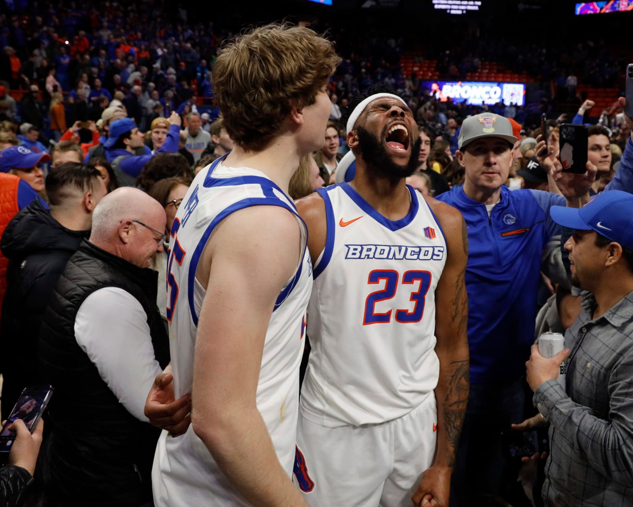 Boise State's Naje Smith (23) and Lukas Milner celebrate their win over San Diego State during the second half of an NCAA college basketball game in Boise, Idaho, Tuesday, Feb. 28, 2023. (AP Photo/Otto Kitsinger)