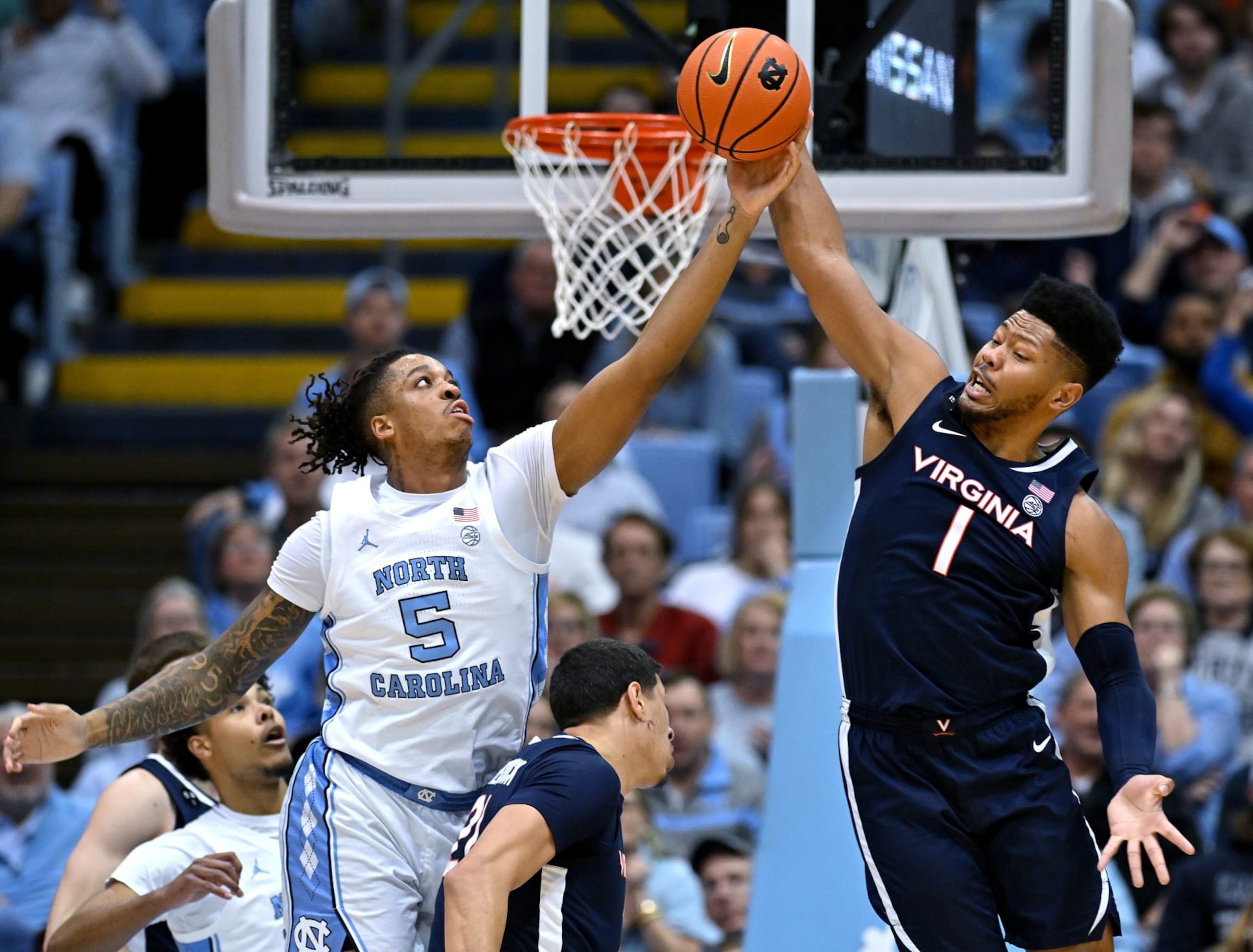 CHAPEL HILL, NORTH CAROLINA - FEBRUARY 25: Armando Bacot #5 of the North Carolina Tar Heels battles Jayden Gardner #1 of the Virginia Cavaliers for a rebound during the first half of their game at the Dean E. Smith Center on February 25, 2023 in Chapel Hill, North Carolina. (Photo by Grant Halverson/Getty Images)