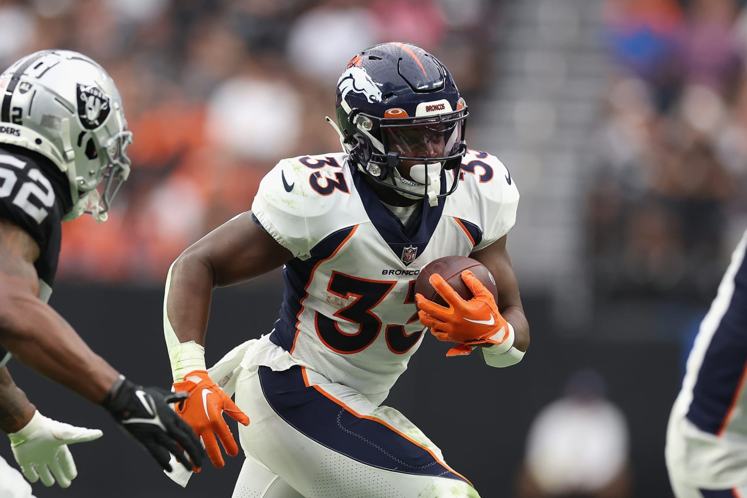 LAS VEGAS, NEVADA - OCTOBER 02: Running back Javonte Williams #33 of the Denver Broncos rushes the football against the Las Vegas Raiders during the first half of the NFL game at Allegiant Stadium on October 02, 2022 in Las Vegas, Nevada. The Raiders defeated the Broncos 32-23. (Photo by Christian Petersen/Getty Images)