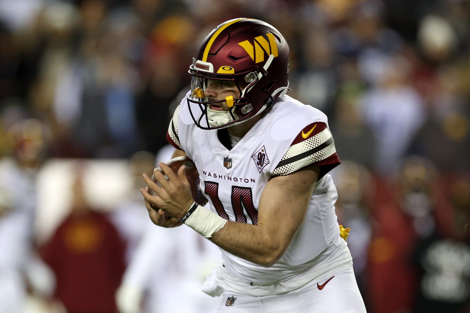 LANDOVER, MARYLAND - JANUARY 08: Quarterback Sam Howell #14 of the Washington Commanders runs with the ball against the Dallas Cowboys at FedExField on January 08, 2023 in Landover, Maryland. (Photo by Rob Carr/Getty Images)