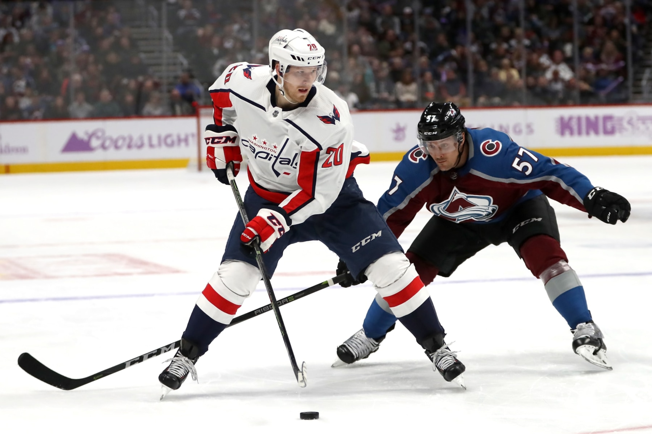 DENVER, CO - NOVEMBER 16:  Lars Eller #20 of the Washington Capitals looks for an opening against Gabriel Bourque #57 of the Colorado Avalanche in the third period at the Pepsi Center on November 16, 2018 in Denver, Colorado.  (Photo by Matthew Stockman/Getty Images)