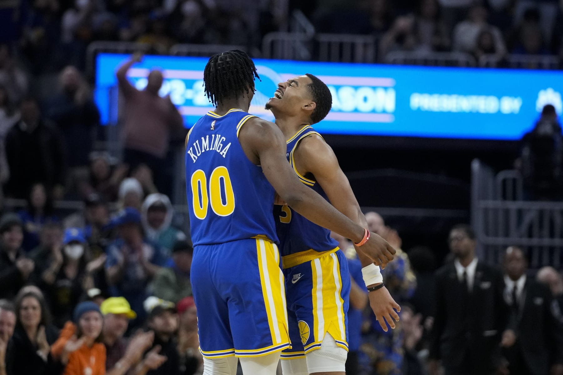 Golden State Warriors forward Jonathan Kuminga, left, celebrates with guard Jordan Poole after scoring against the Charlotte Hornets during the second half of an NBA basketball game in San Francisco, Tuesday, Dec. 27, 2022. (AP Photo/Godofredo A. Vásquez)