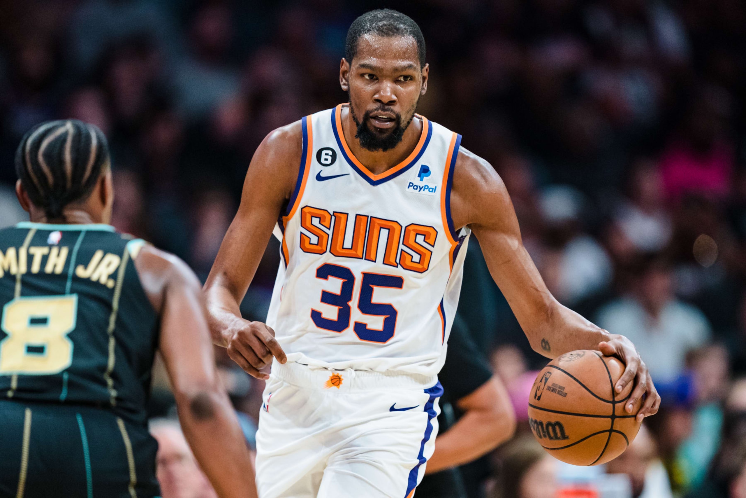 CHARLOTTE, NORTH CAROLINA - MARCH 01: Kevin Durant #35 of the Phoenix Suns brings the ball up court while guarded by Dennis Smith Jr. #8 of the Charlotte Hornets in the second quarter during their game at Spectrum Center on March 01, 2023 in Charlotte, North Carolina. NOTE TO USER: User expressly acknowledges and agrees that, by downloading and or using this photograph, User is consenting to the terms and conditions of the Getty Images License Agreement. (Photo by Jacob Kupferman/Getty Images)