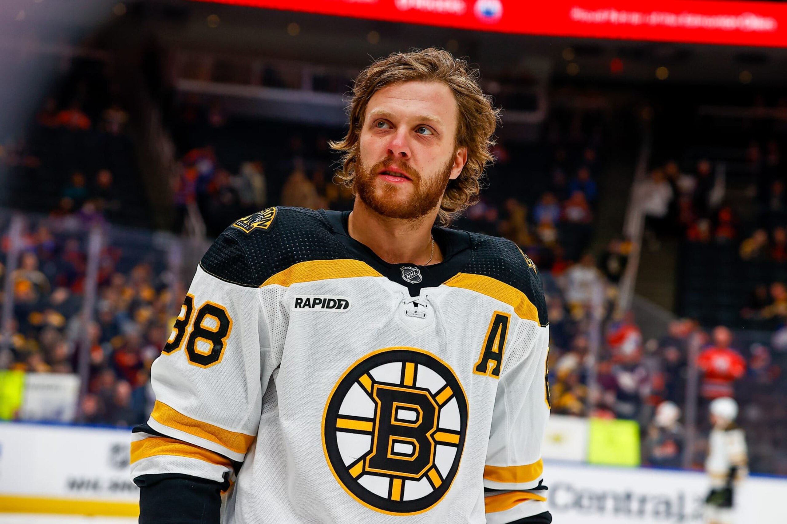 EDMONTON, AB - FEBRUARY 27: Boston Bruins Right Wing David Pastrnak (88) smiles at a fan sign in warm ups of the Edmonton Oilers game versus the Boston Bruins on February 27, 2023 at Rogers Place in Edmonton, AB. (Photo by Curtis Comeau/Icon Sportswire via Getty Images)